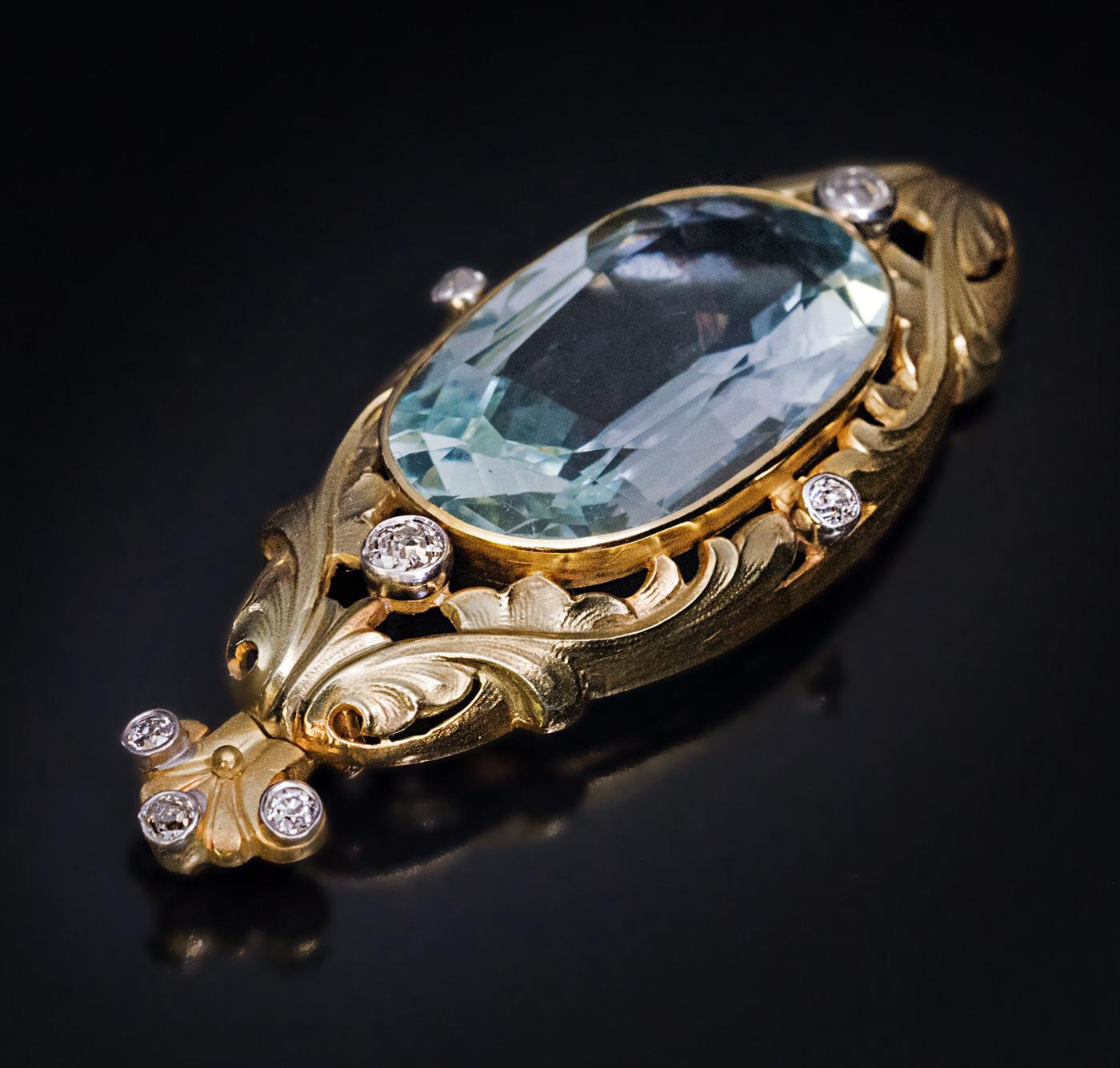 Circa 1910s

An antique 14K greenish-yellow pendant features a large oval natural aquamarine. The aquamarine is set in an openwork scrolling foliage motif frame embellished with old cut diamonds set in silver bezels.

The aquamarine measures 26.84 x