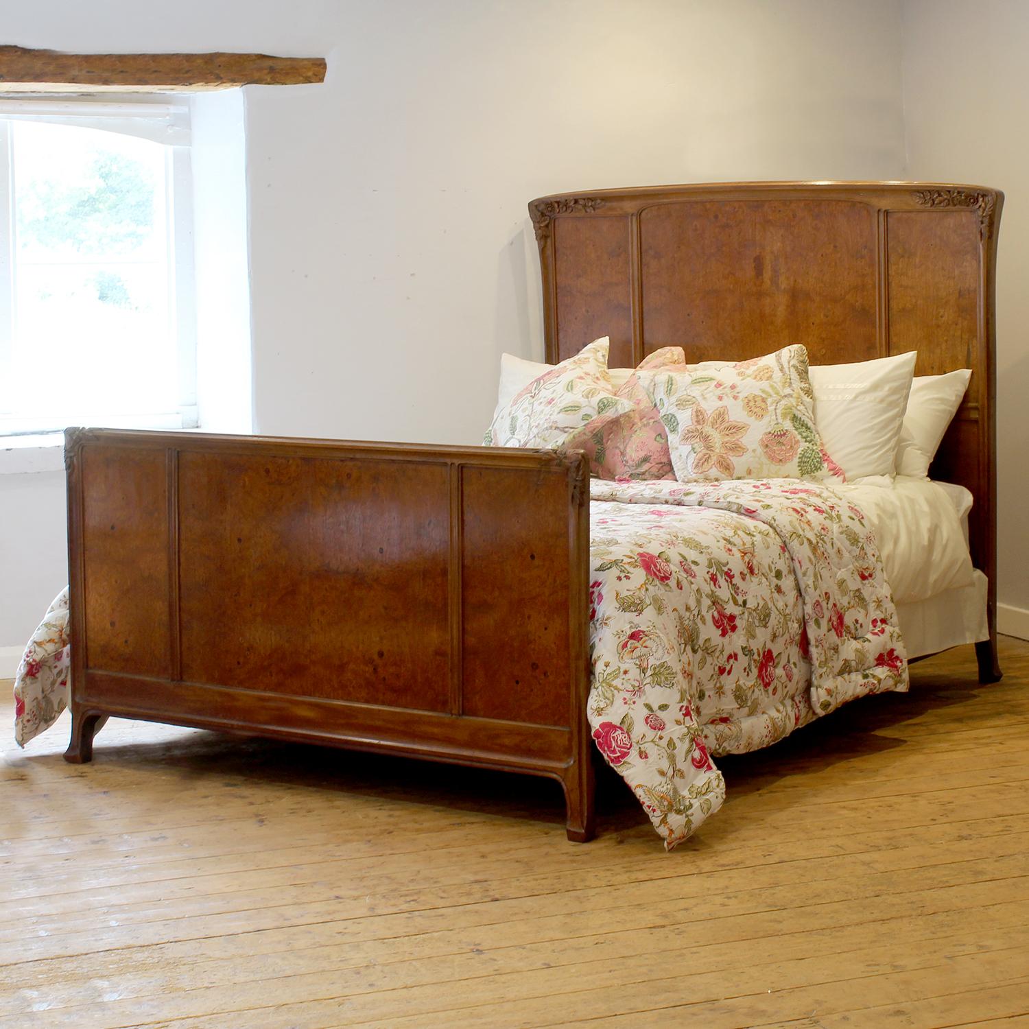 An attractive Art Nouveau French antique bed with shaped headboard and panels in burr walnut and delicate floral carvings on the shoulders.

This bed accepts a US Queen Size (or UK King Size), 5ft wide (60 in), base and mattress set.

The price