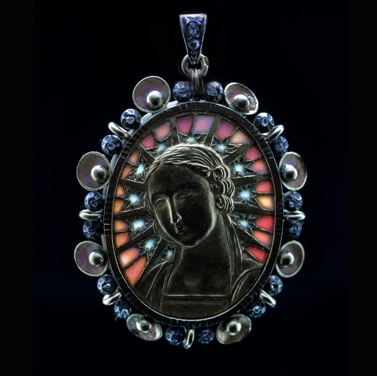 Circa 1900

This very fine Art Nouveau 18K gold Madonna pendant is attributed to a famous Barcelona (Spain) jeweler and artist Luis Masriera. The pendant is embellished with plique à jour and shaded enamels of blue and purple colors. The center