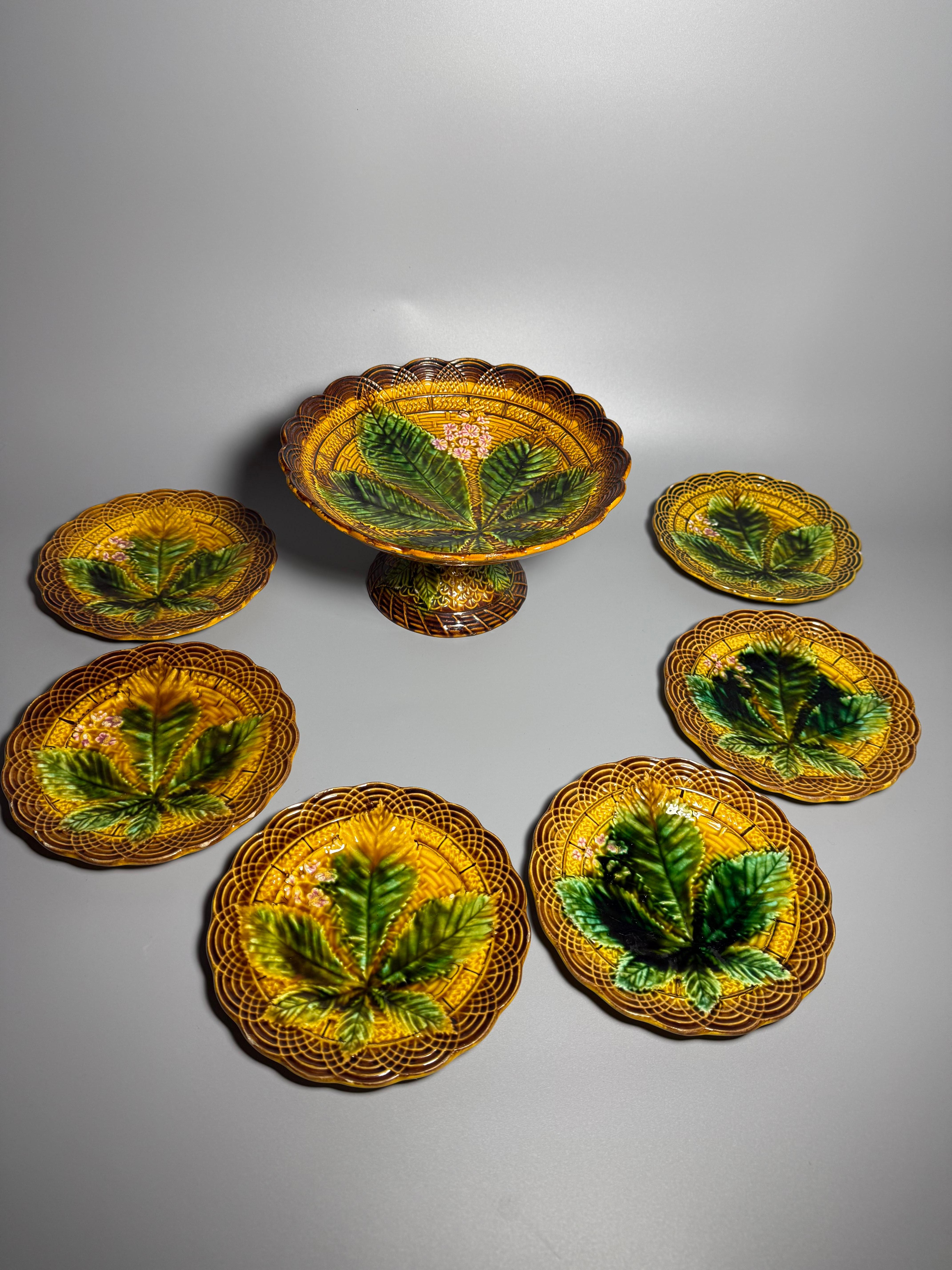 Antique Majolica set
Villeroy & Boch Germany 
1 centre piece/fruit stand 
H 13 cm (5,12 inches)
D 23 cm (9,05 inches)
6 side plates d 17 cm (6,69 inches)

Hand Painted Majolica Pedestal Cake Stand or Fruit Stand, Gold with Raised Green Chestnut