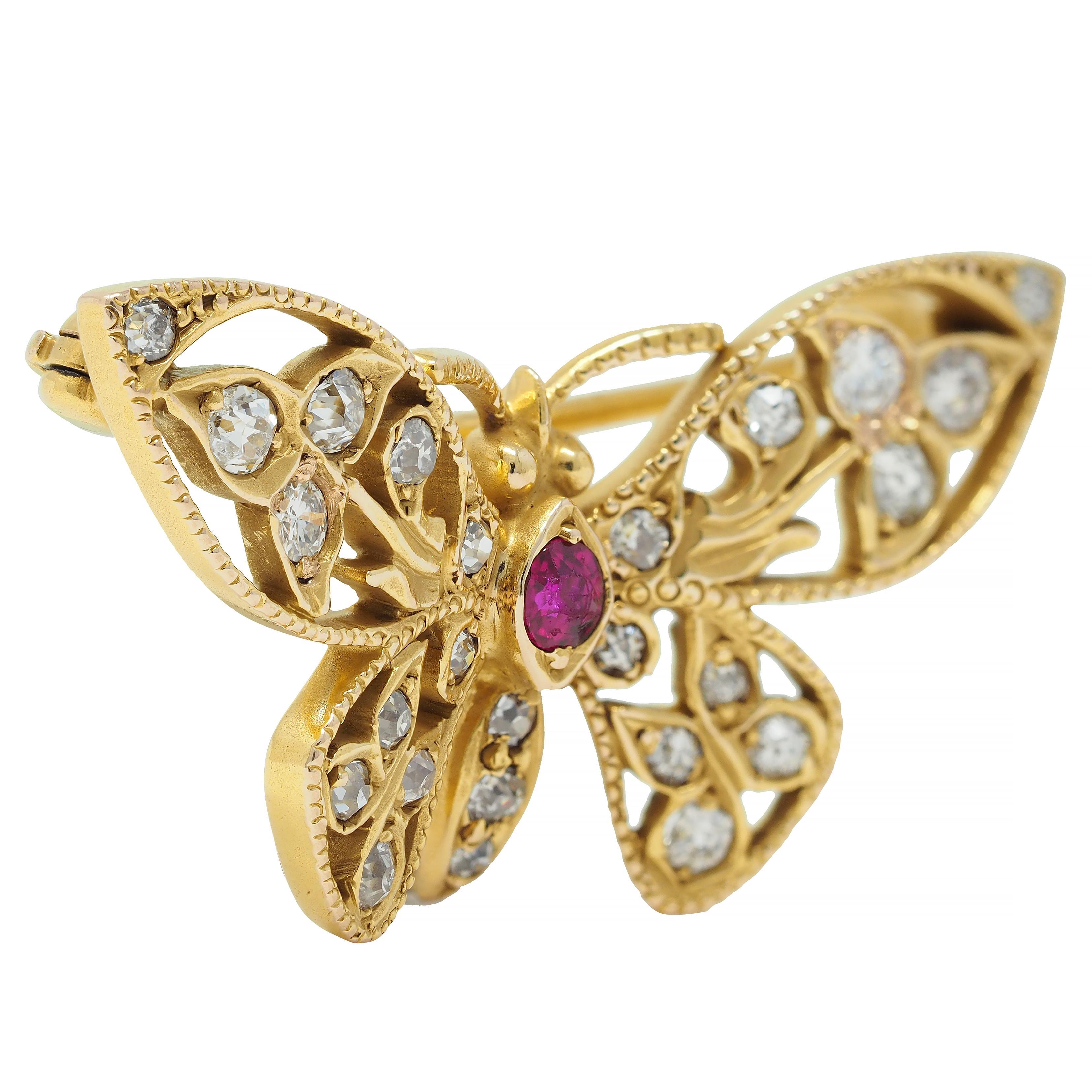 Designed as a stylized butterfly with pierced foliate motif wings with milgrain detail
Centering a round cut ruby body weighing approximately 0.14 carat - medium red
Accented by old European cut diamonds and one transitional bead set throughout