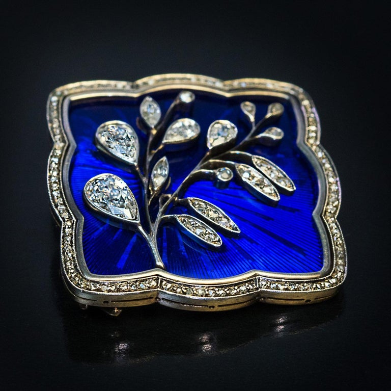 This exquisite Tsarist era brooch / pin was made in Moscow between 1908 and 1917 by a prominent jewelry firm of Feodor Lorie.
The brooch is handcrafted in 14K gold and silver. It features a finely modeled Art Nouveau diamond flower mounted on a