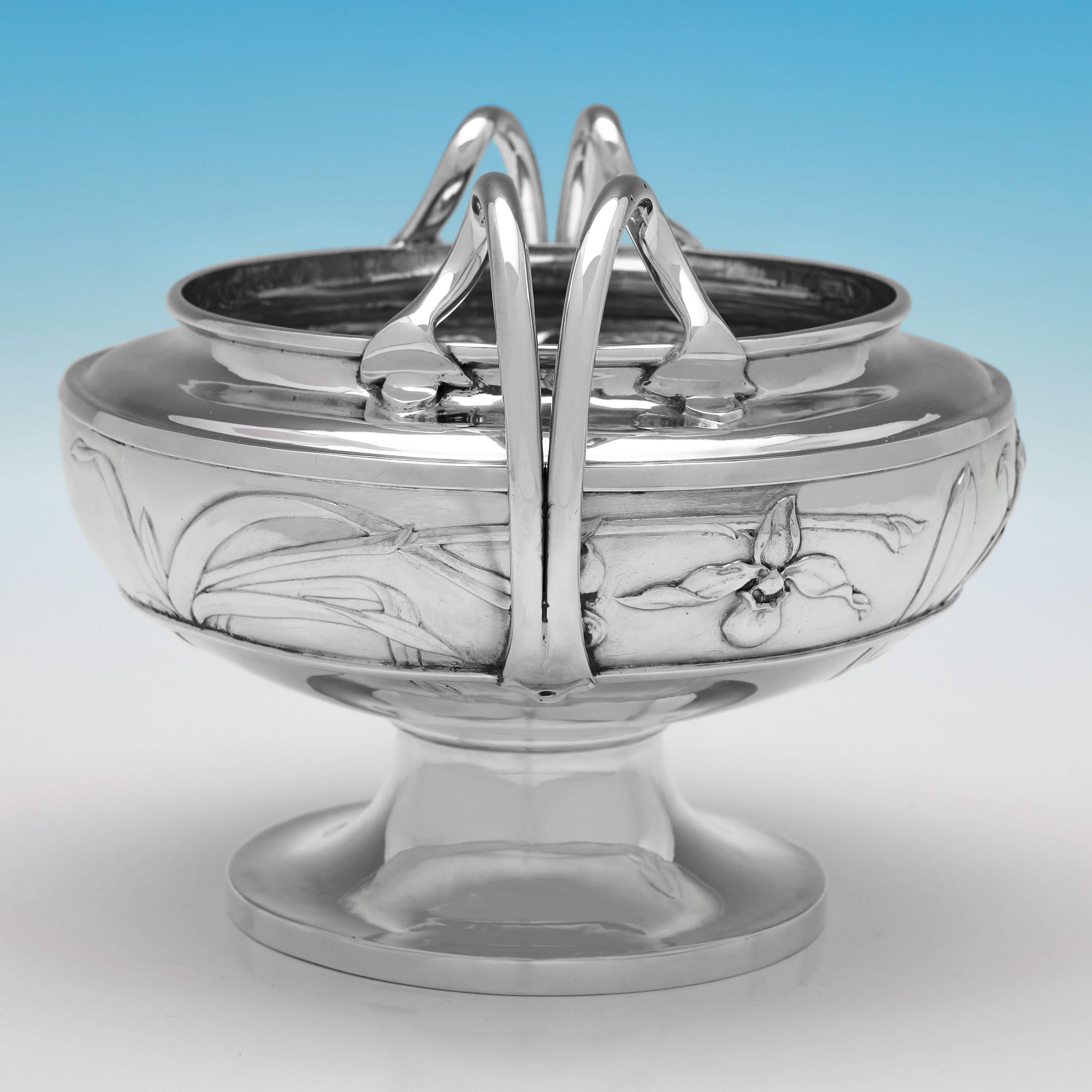 Hallmarked in London in 1907, this attractive, Edwardian, Antique Sterling Silver Bowl, is in the Art Nouveau taste, with chased floral decoration to the body, and loop handles. 

The bowl measures 6.25