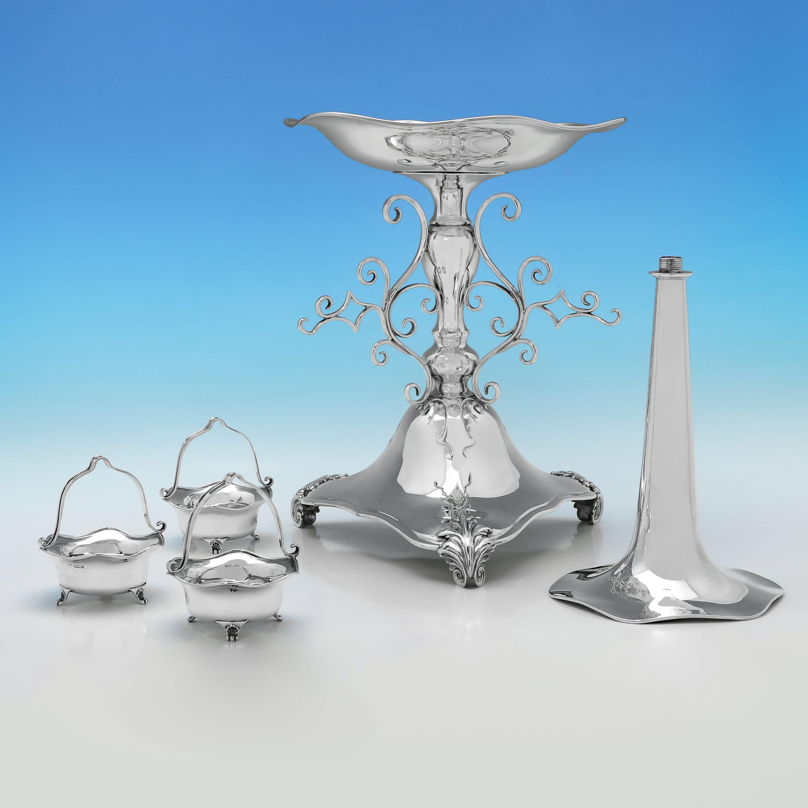 Hallmarked in Sheffield in 1909 by John & William Deakin, this stylish, Art Nouveau, Antique Sterling Silver Epergne or Centrepiece is very large, just the thing for a big dining room, and features a central trumpet vase and three hanging baskets.