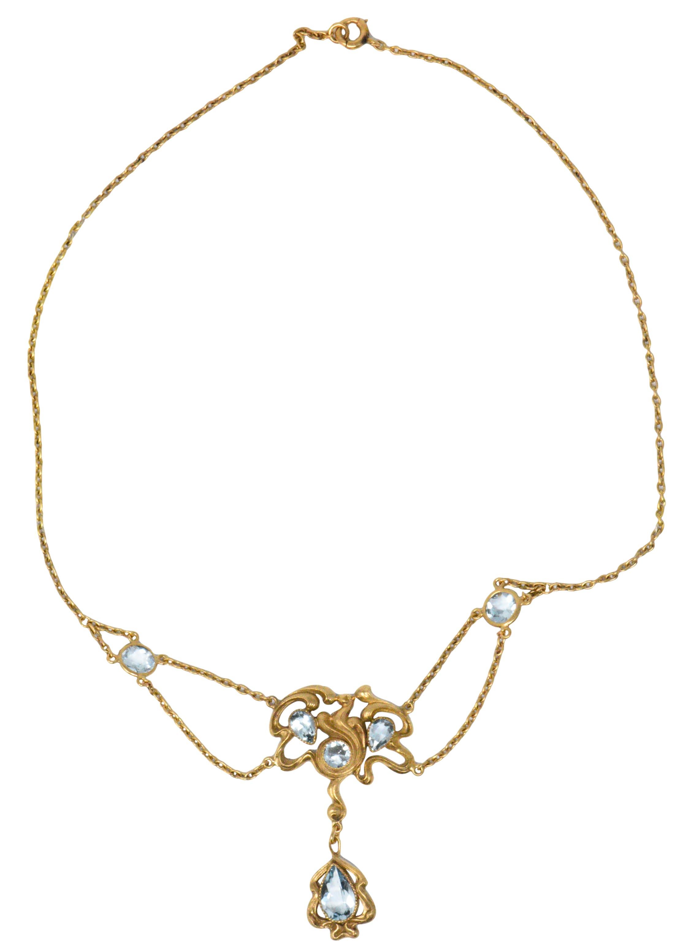 Swag style necklace with rose cut round and pear shaped aquamarines

Centering a free-form flowing gold, referred to as the 