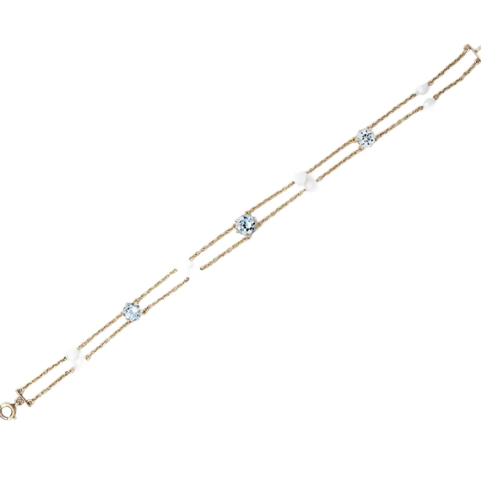 An art nouveau period aquamarine, and natural pearl bracelet in 14 karat yellow gold.

Set with three antique European cut aquamarine of 3.50 carats total weight strung on hand wrought chain links.

Accented by eight natural pearls of approximately