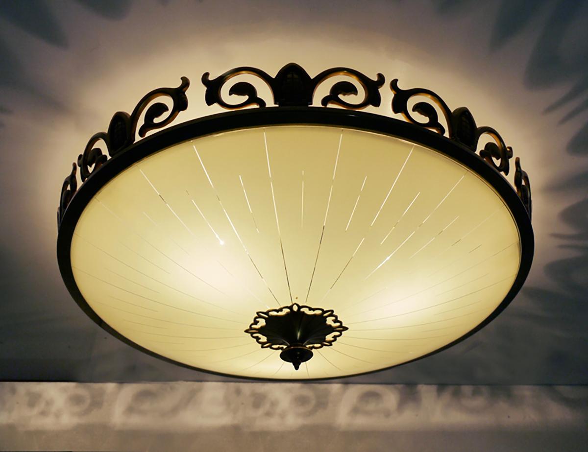 Elegant Art Nouveau / Art Deco flush mount ceiling light with a round creme glass shade and on a solid brass frame with golden finals. Made by Kaiser Lighting, Germany in the 1930s. Chandelier illuminates beautifully and offers a lot of indirect