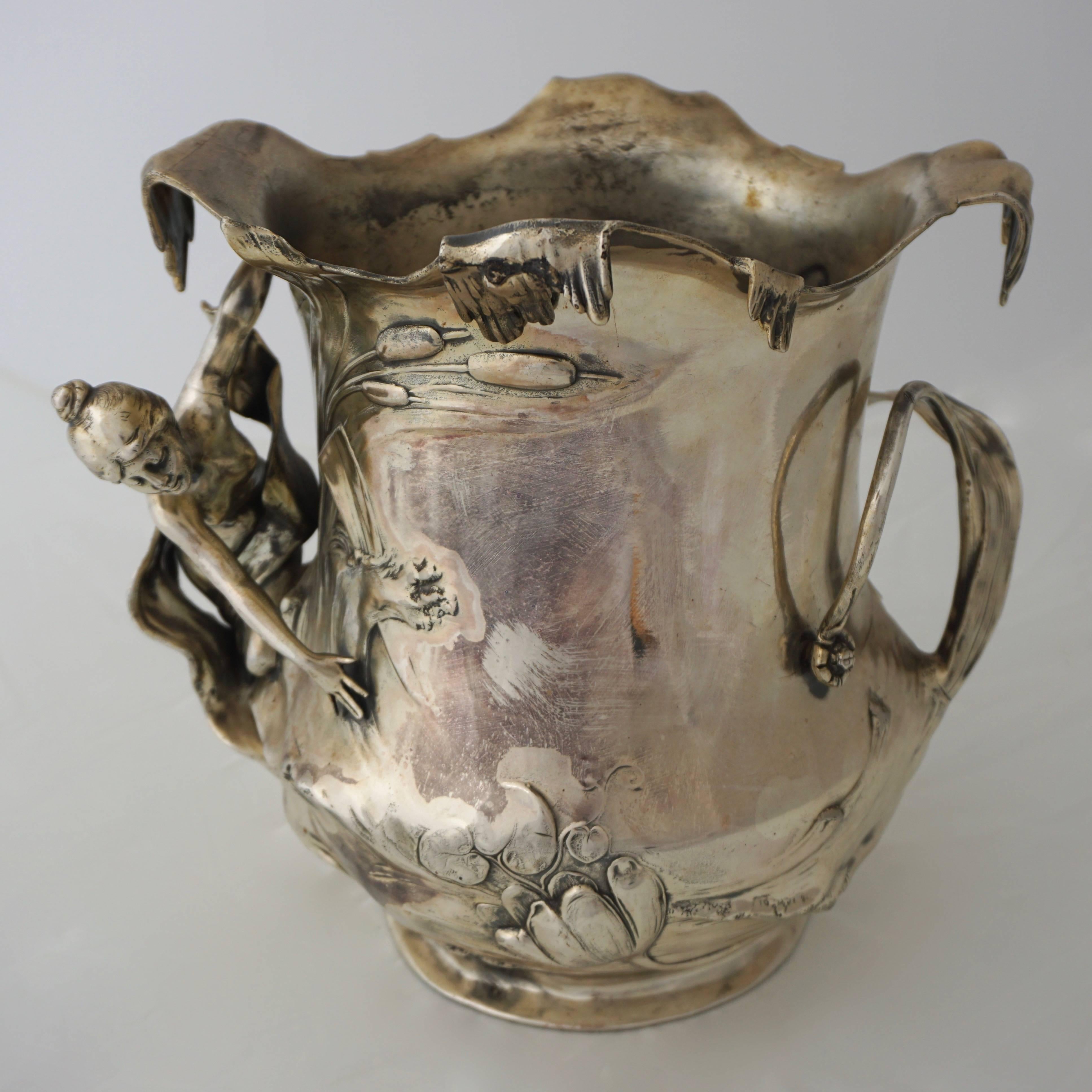 Art Nouveau WMF silver plated pewter champagne bucket with high relief decoration, Germany, circa 1906.
In very good original condition, as shown in the pictures. Can also be used as a vase.

By 1900 WMF was the world's largest producer of