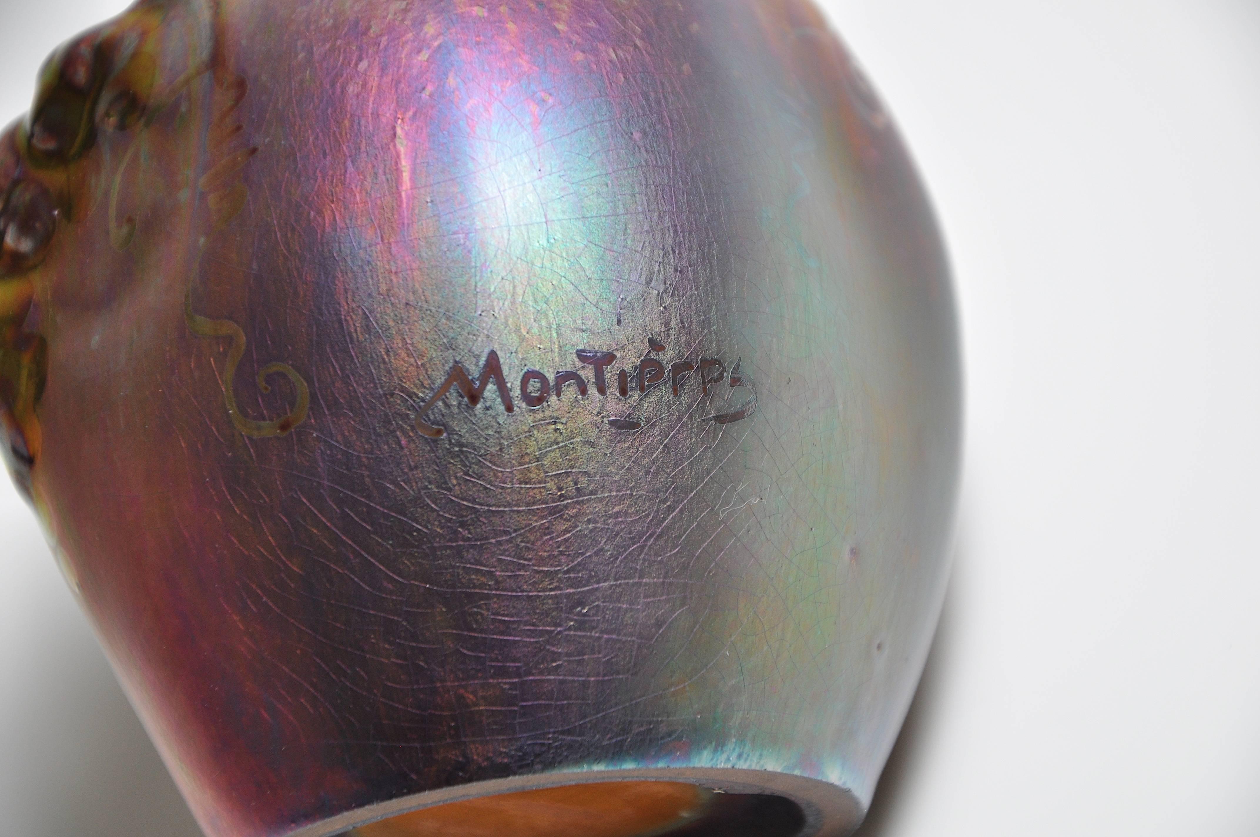 Art Nouveau Art Pottery Montieres red green lustre vase pot.

A superb small iridescent art nouveau vase with a lustre-glazed finish.
It is very tactile, fitting superbly in ones hand like an apple.
Signed ‘Montieres’ by the factory based at