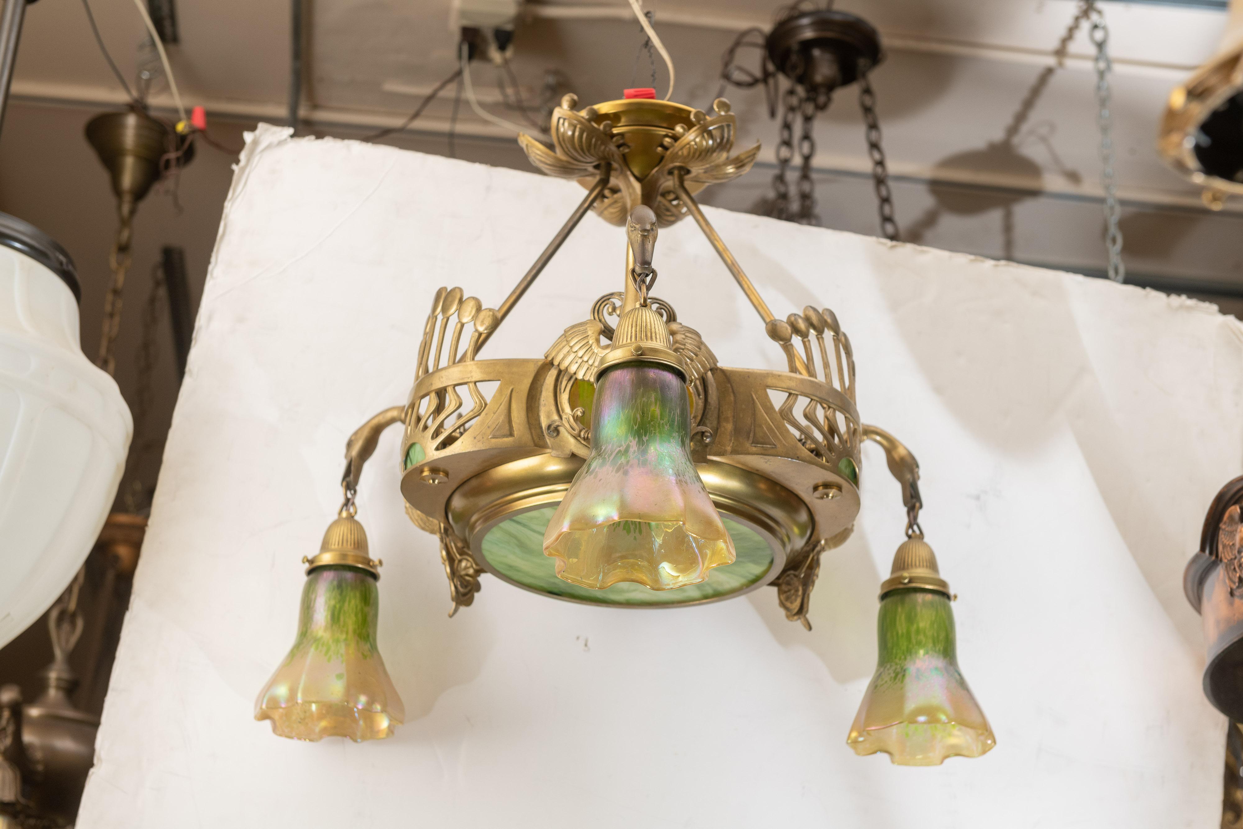 We are offering an exceptional piece of antique lighting. So many nice features. The glass shades are hand blown art glass and probably done by Loetz. The areas of flat glass are a match. The cast swans are probably the most notable work on this