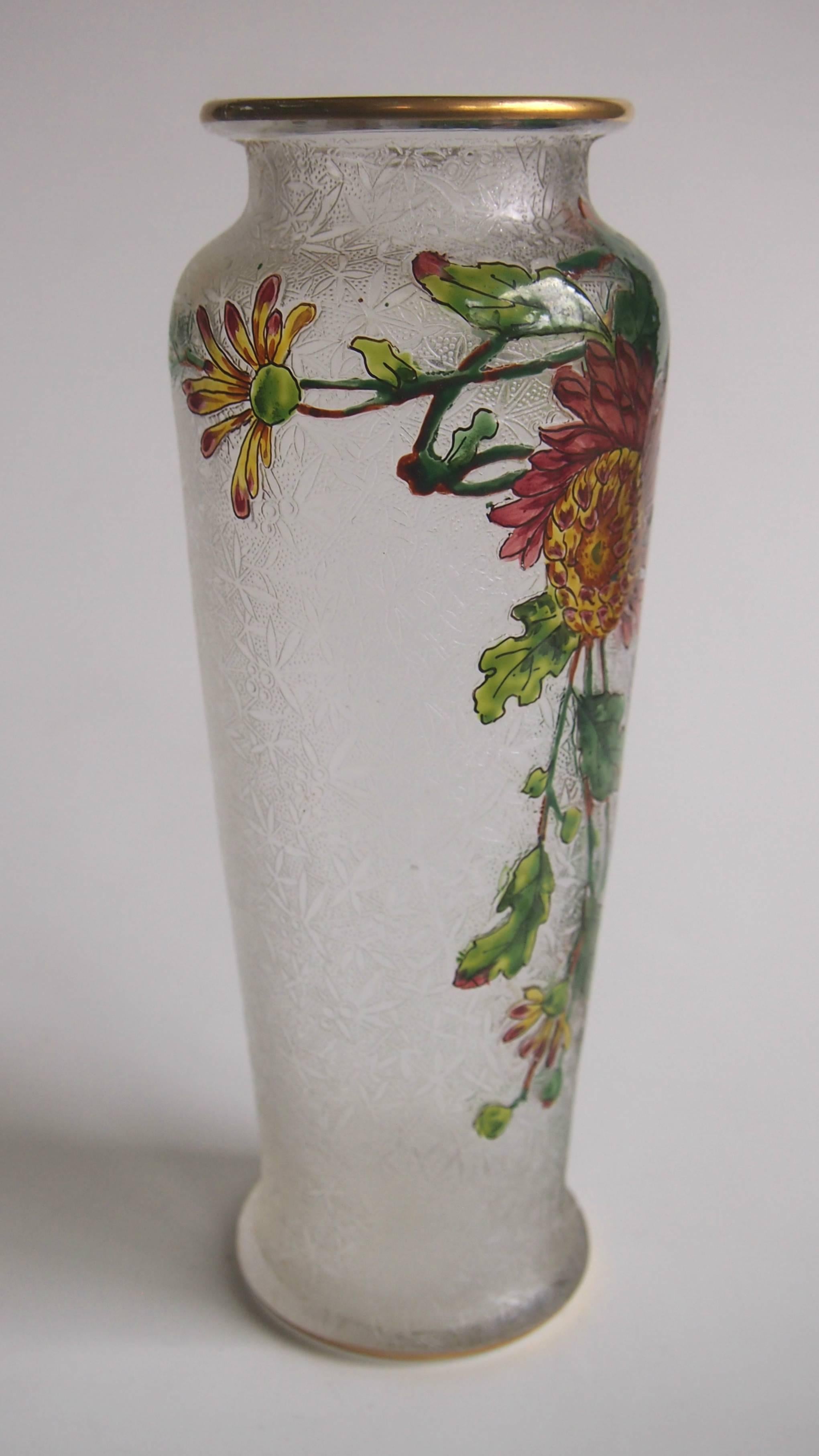 A superb Art Nouveau Baccarat crystal acid cut back vase with vibrant polychrome enamelled flowers and leaves with a gilded top and bottom. As with most early Baccarat cameo and acid cutbacks there is a fine pattern detailed in the clear layer.