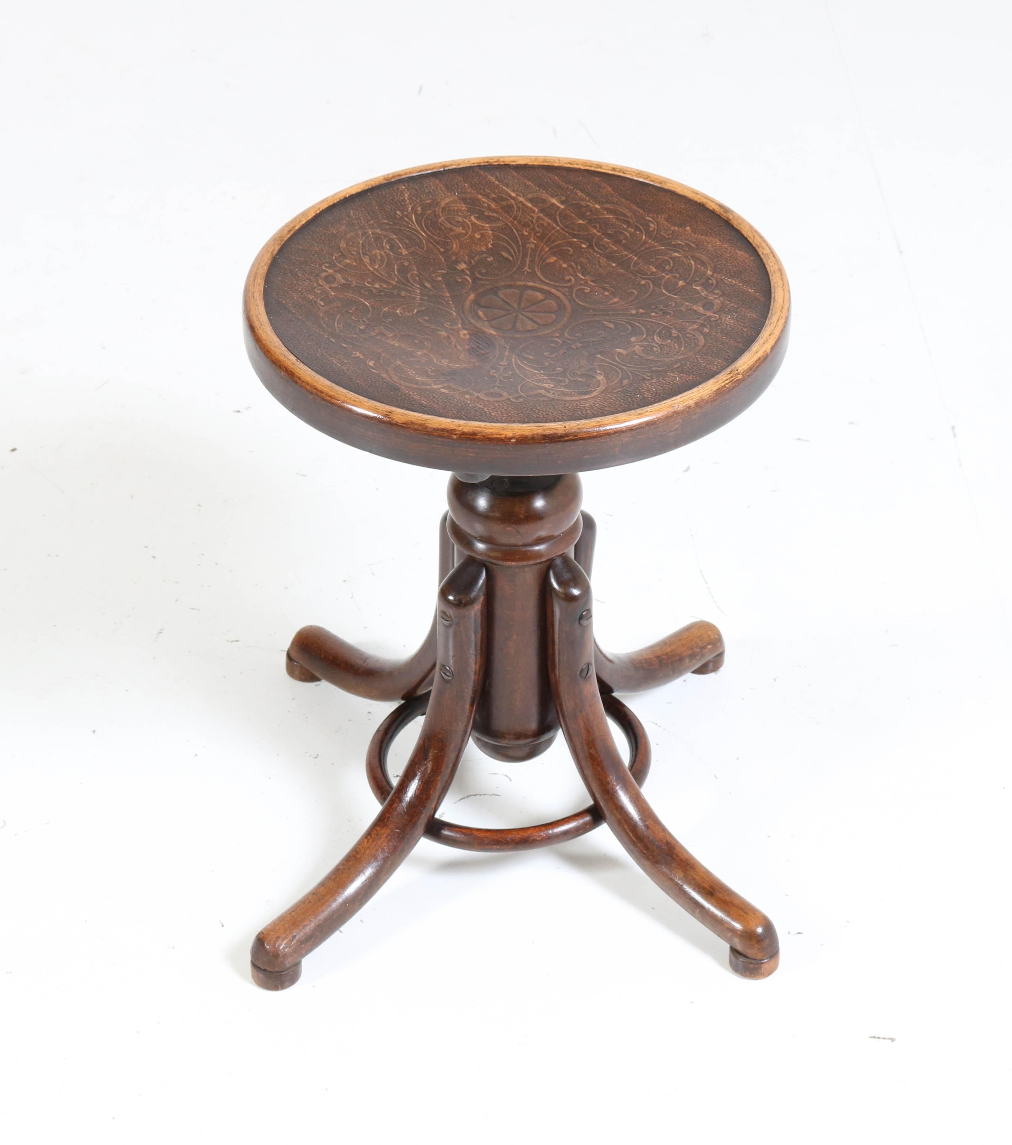 Wonderful Art Nouveau revolving stool.
Design by Thonet Austria, circa 1910.
Beech bentwood with original printed seating surface.
Adjustable in height.
In good original condition with minor wear consistent with age and wear,
preserving a