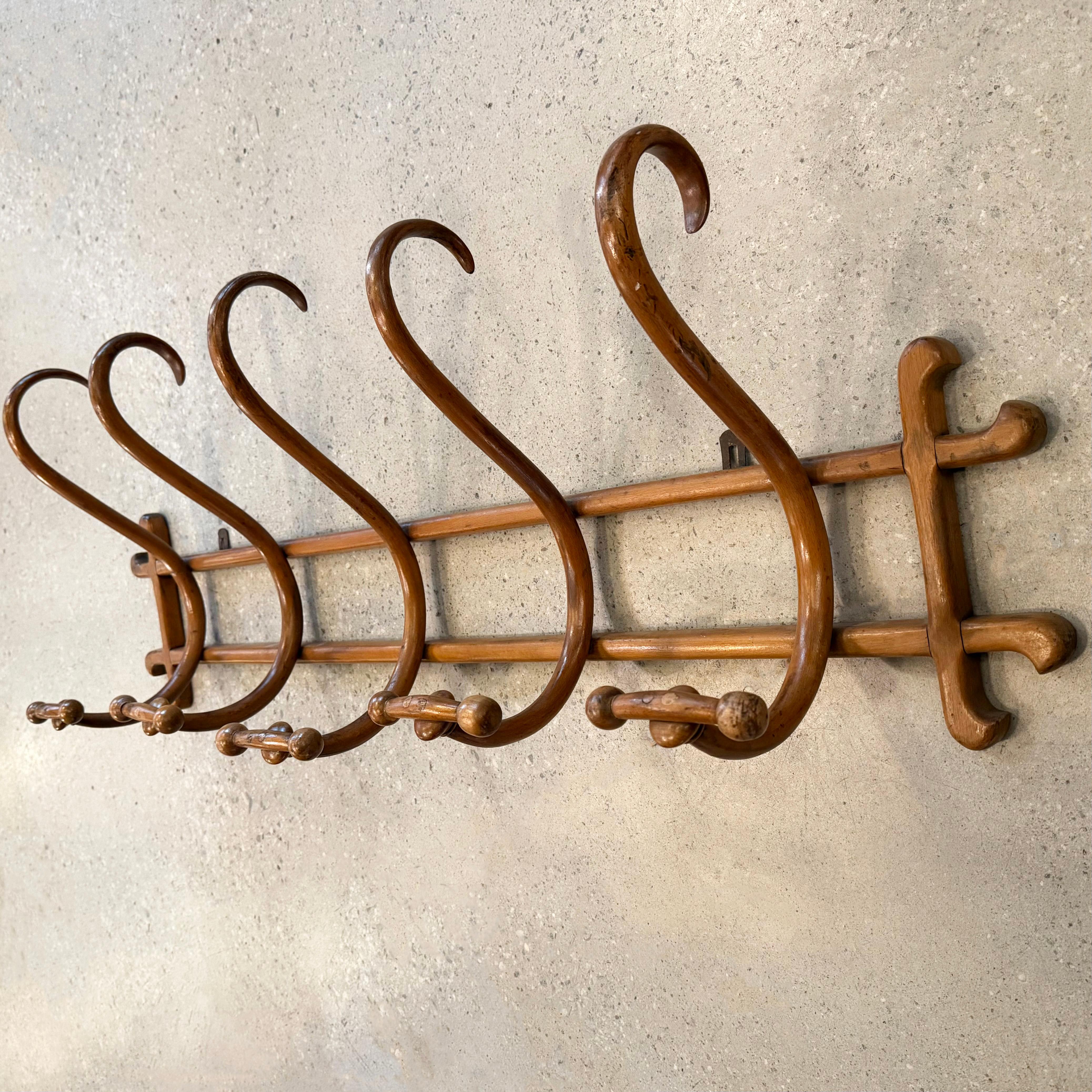 This jugenstil, art nouveau maple bentwood wall coatrack was designed by the Austrian furniture company Thonet, originally called Gebrüder Thonet or Thonet Brothers, a family owned business founded in the mid 19th-century. The Thonet family is