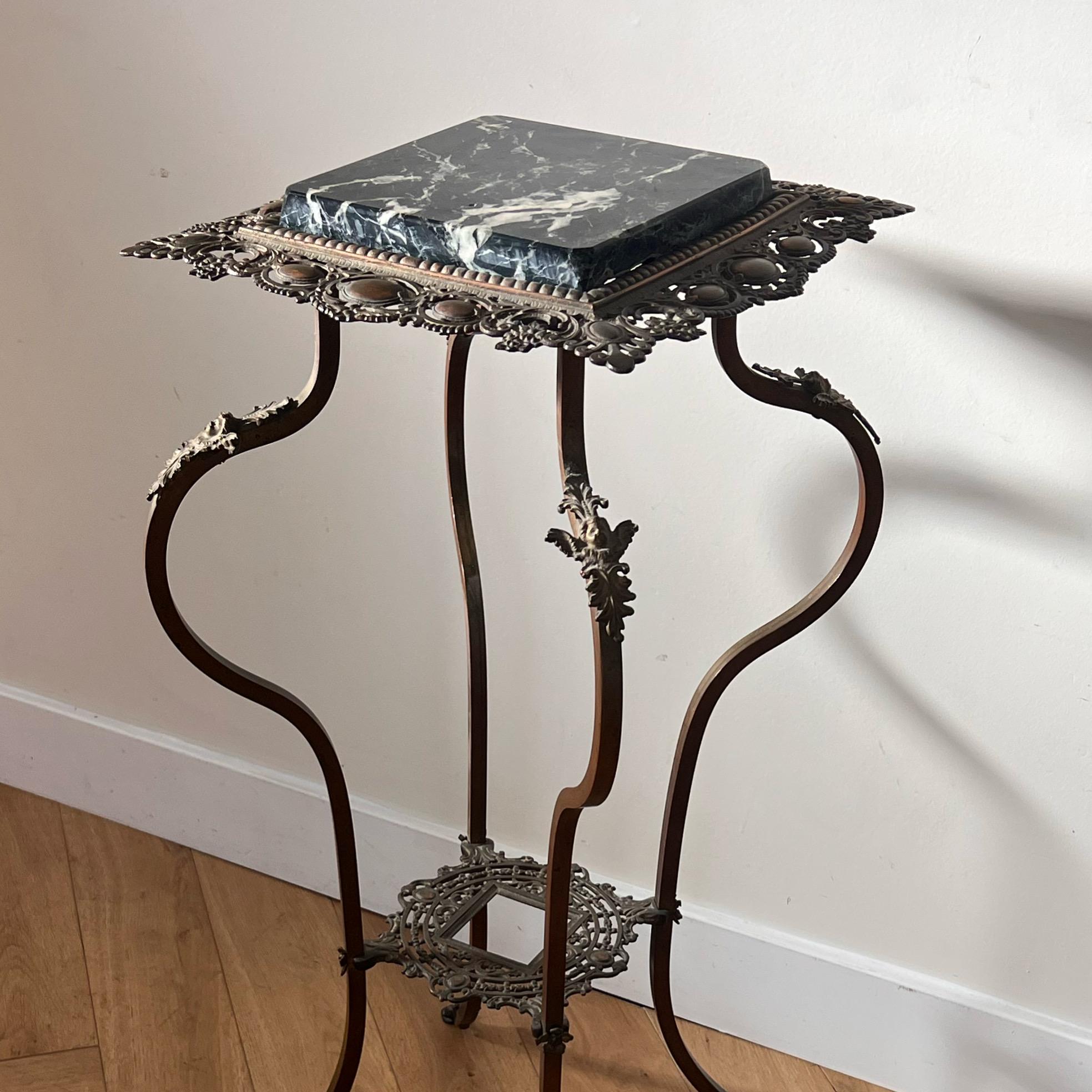 A stunning Victorian jardinière occasional table / pedestal crafted of a metal base - brass - with a black marble top inlay. Circa fin de siècle late 1800s, or perhaps début de siècle, this piece marries elements of belle époque with art nouveau,