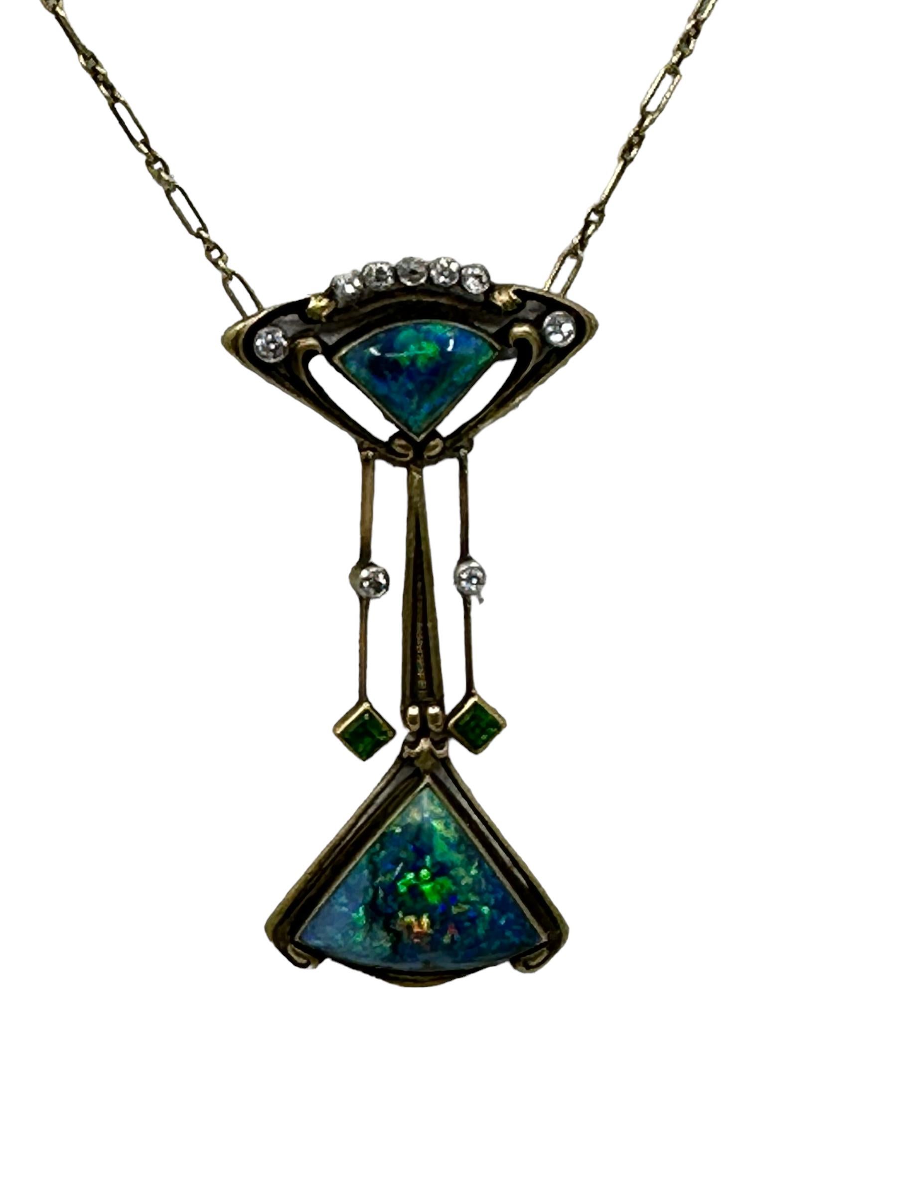 Stunning Art Nouveau Black Opal Diamond and Demantoid Garnet Necklace set in 14K Gold,
Articulated pendent supporting two fancy-cut black opals, accented by old mine-cut diamonds and demantoid garnets.
• Length 16 inches (40cm) 
• Pendent 2