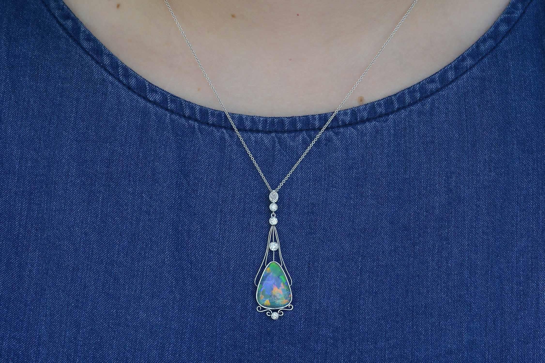  A most enchanting necklace that is definitely swoon-worthy. This original antique, circa 1910 lavalier subtly whispers Art Nouveau. The simple, classic, wispy design is centered by a natural, single black opal from the famous Lightning Ridge mine