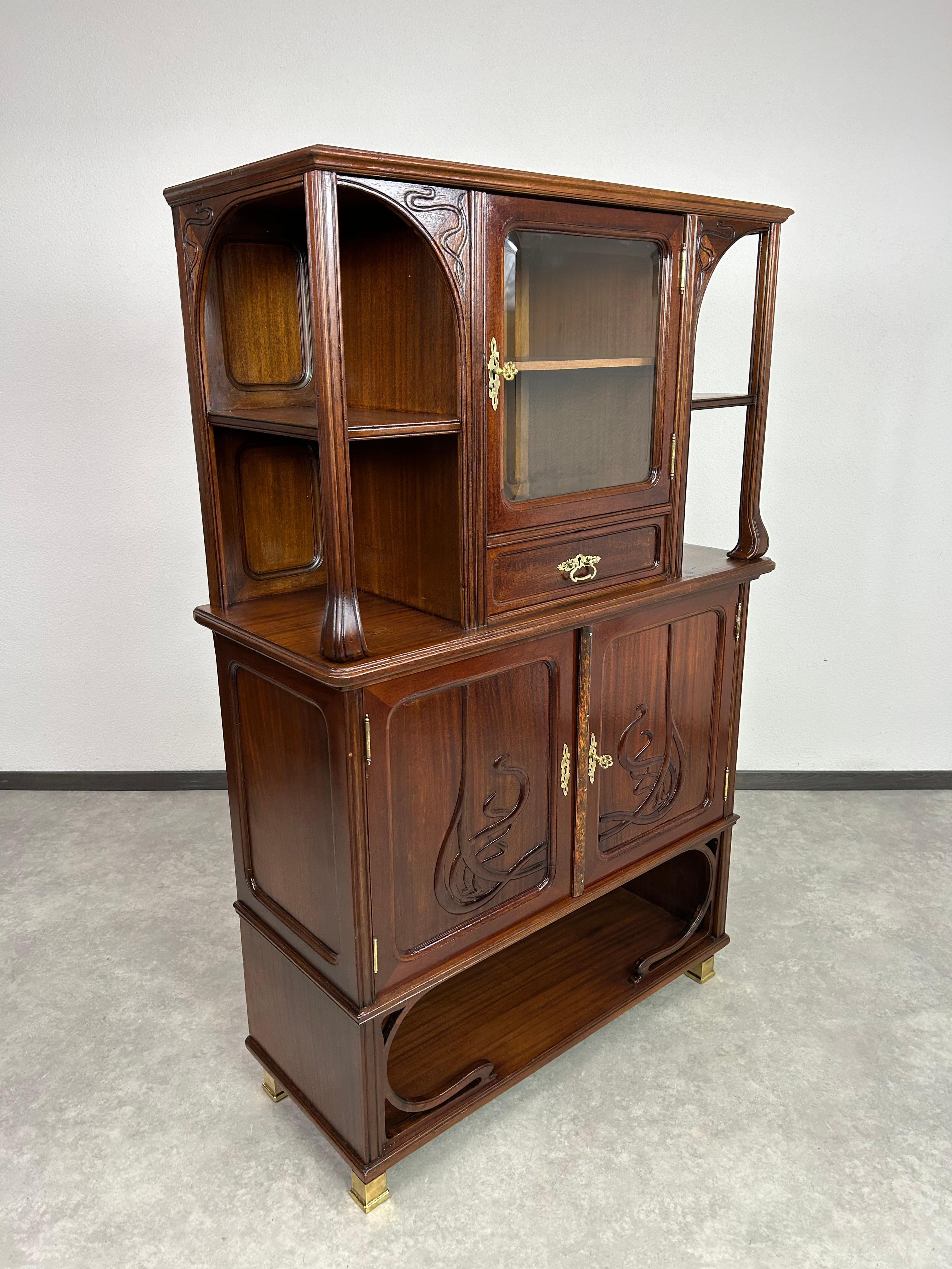 Art nouveau bookcase with brass leg endings. Professionally stained and repolished.
