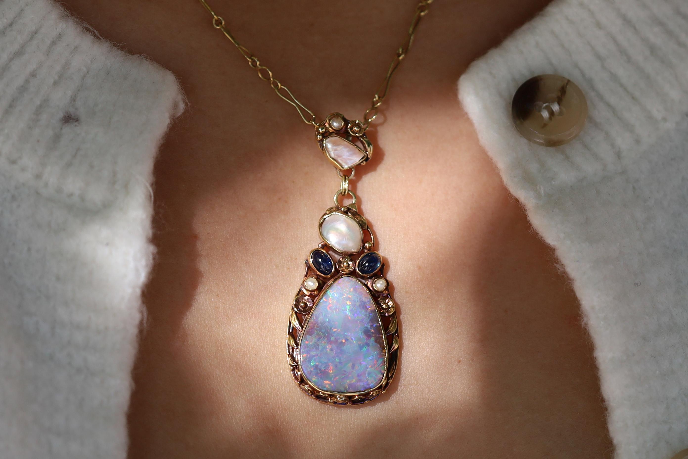 The Art Nouveau era was a short-lived period of design which produced the most naturalistic and beautiful designs in history. This boulder opal necklaces encompasses all of the classic elements. Centering on 
 a pear shaped gem exhibiting exciting