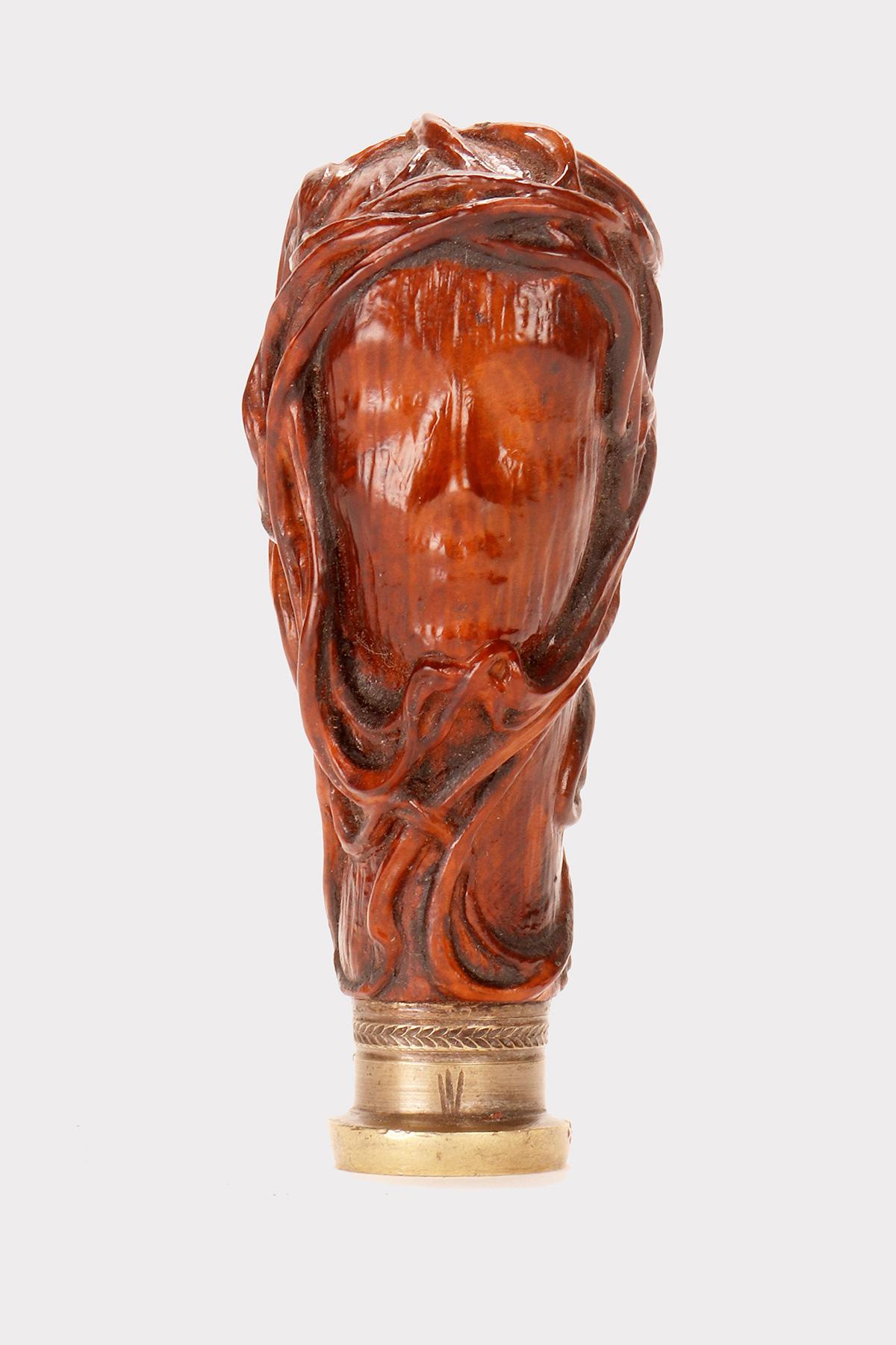 An Art Nouveau seal made of carved Boxwood, depicting a veiled woman's face, wrapped in intertwined racemes. Oval-shaped bronze matrix with engraved noble coat of arms, a nine-pointed crown, title of count. Italy, early 20th century.