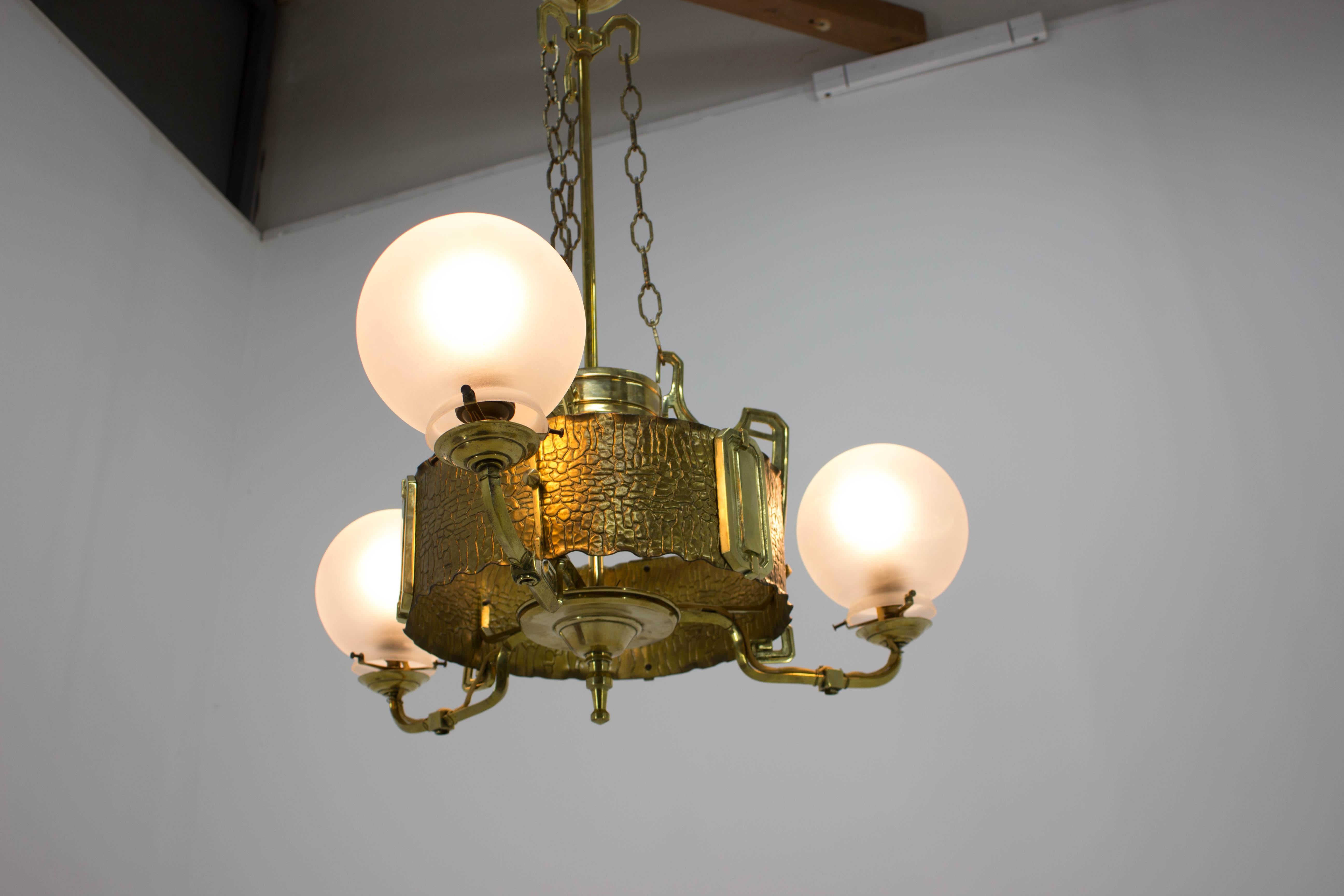 Formerly gas Art Nouveau brass chandelier from the beginning of 20th century, then remade for electricity, now new rewired, 3xE27, 3x60W, up to 250V. Completely restored.
