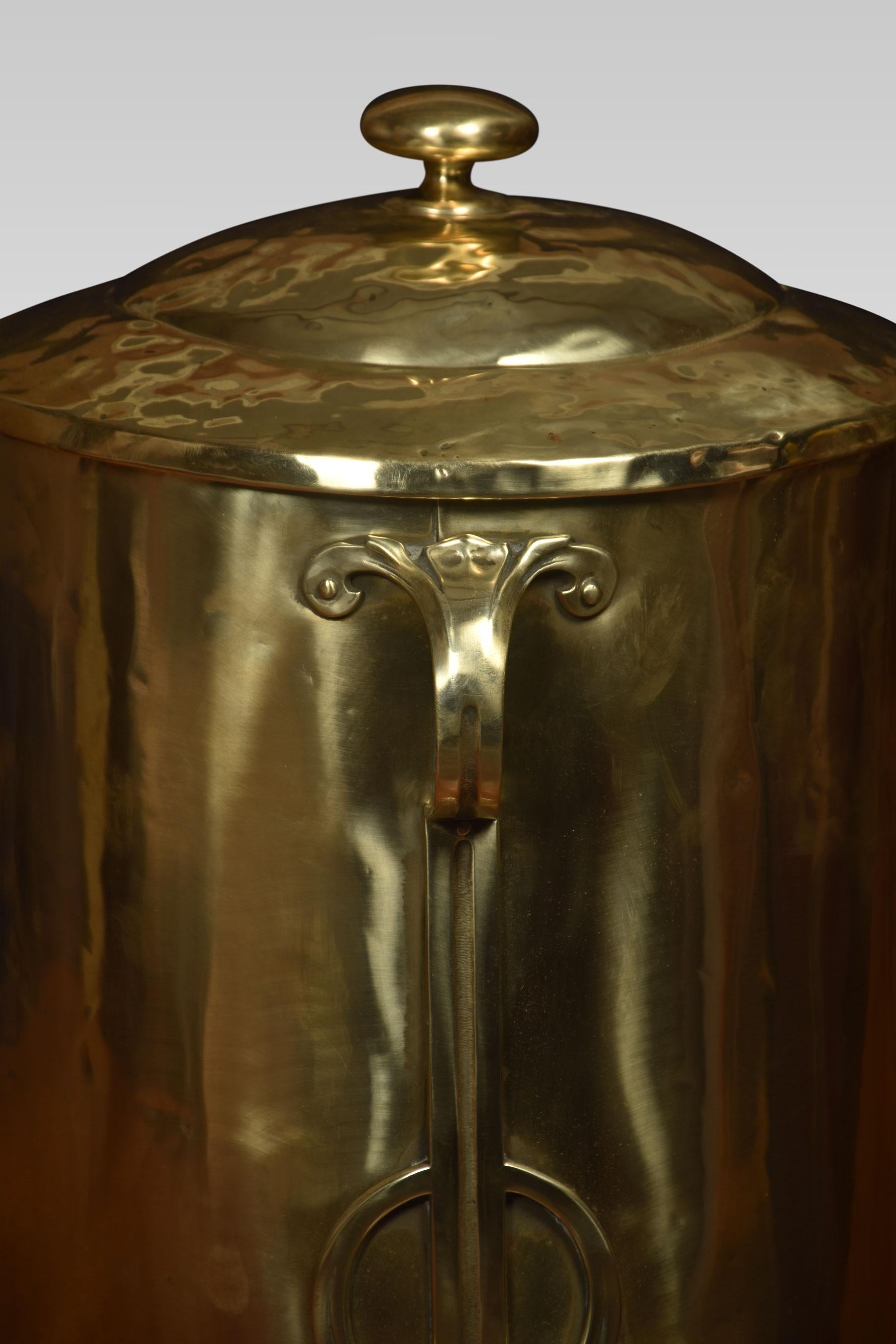 Art Nouveau brass coal bin of cylindrical form, the removable lid opening to reveal the original tin liner. Above three strap-work handles, all raised up on paw feet.
Dimensions
Height 17.5 Inches
Width 14.5 Inches
Depth 14.5 Inches.
 