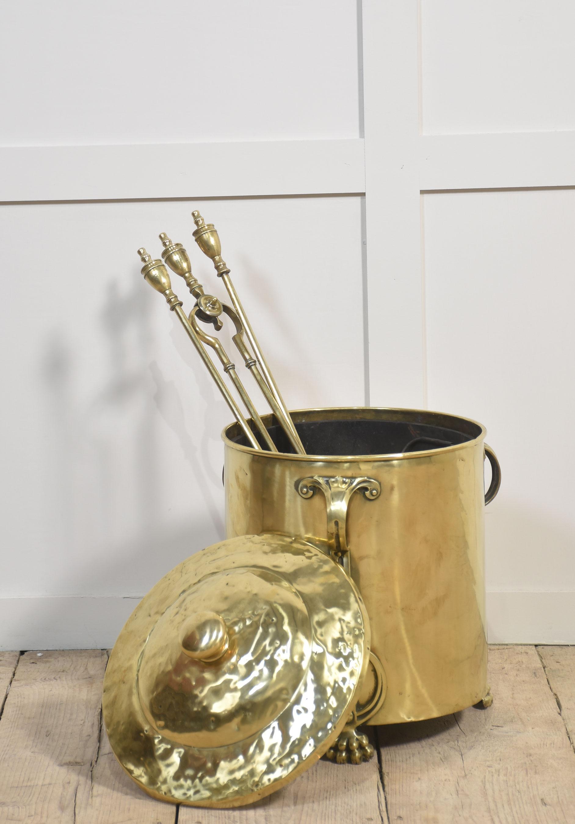 Art Nouveau brass coal bin of cylindrical form, the removable lid opening to reveal the original tin liner. Above three strap-work handles, all raised up on paw feet.
Dimensions
Height 17.5 Inches
Width 14.5 Inches
Depth 14.5 Inches