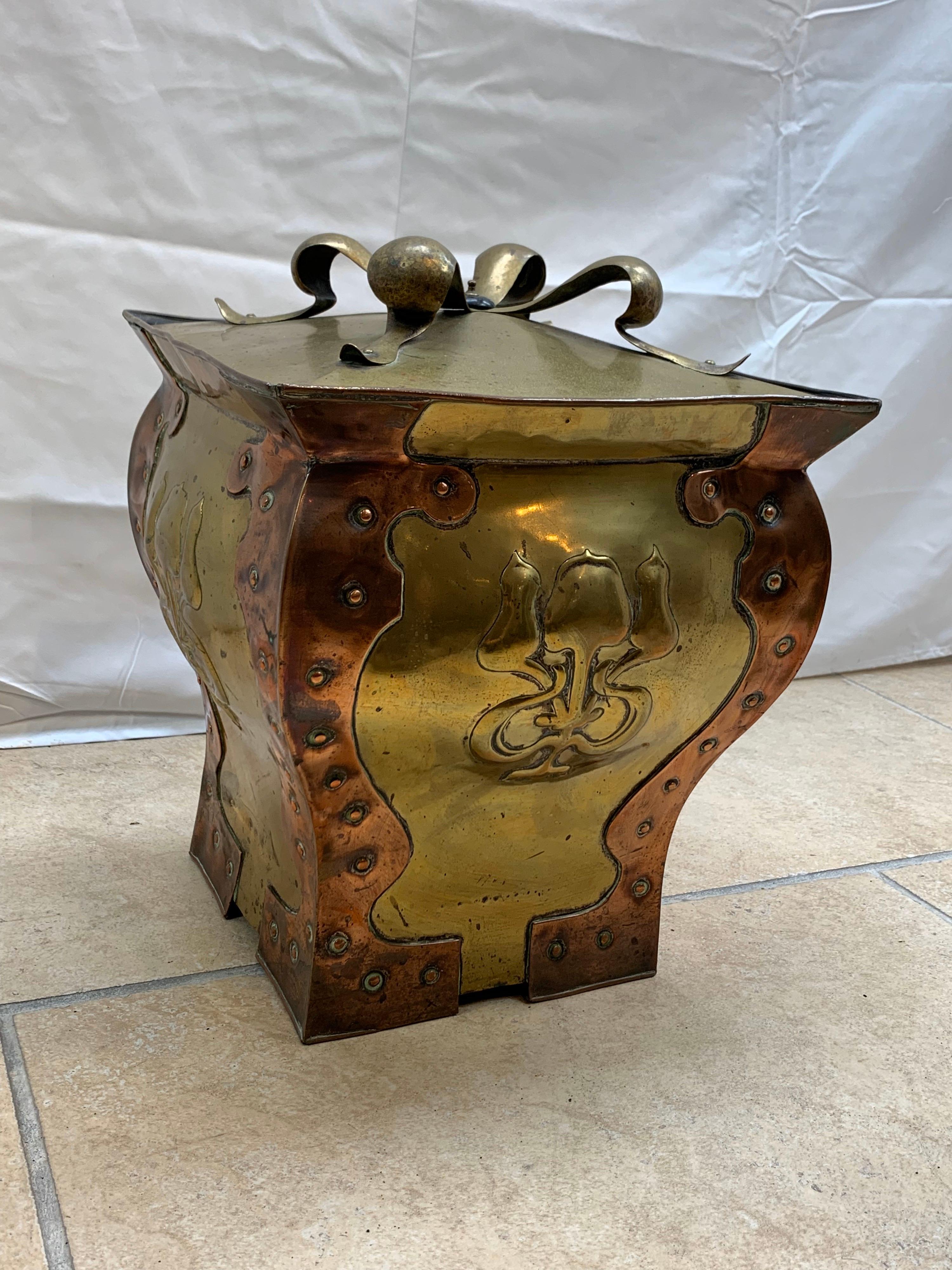 Exceptional Art Nouveau brass with copper coal bucket with ribbon on top.