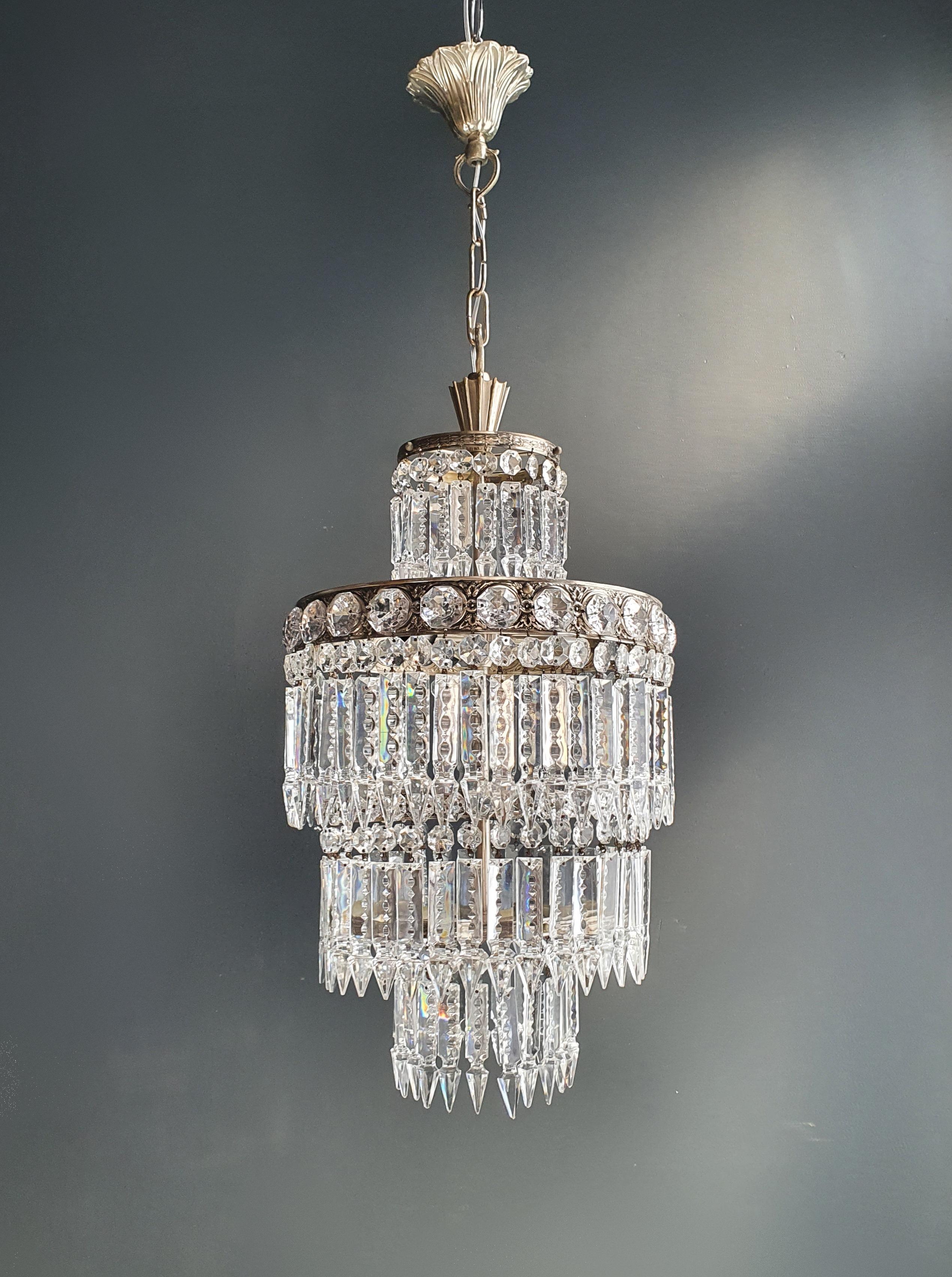Introducing our exquisite smaller chandelier - a masterpiece of elegance and style that will fit seamlessly into any room. With its compact dimensions and stunning details, this chandelier will add a touch of luxury and charm to your home.

Key