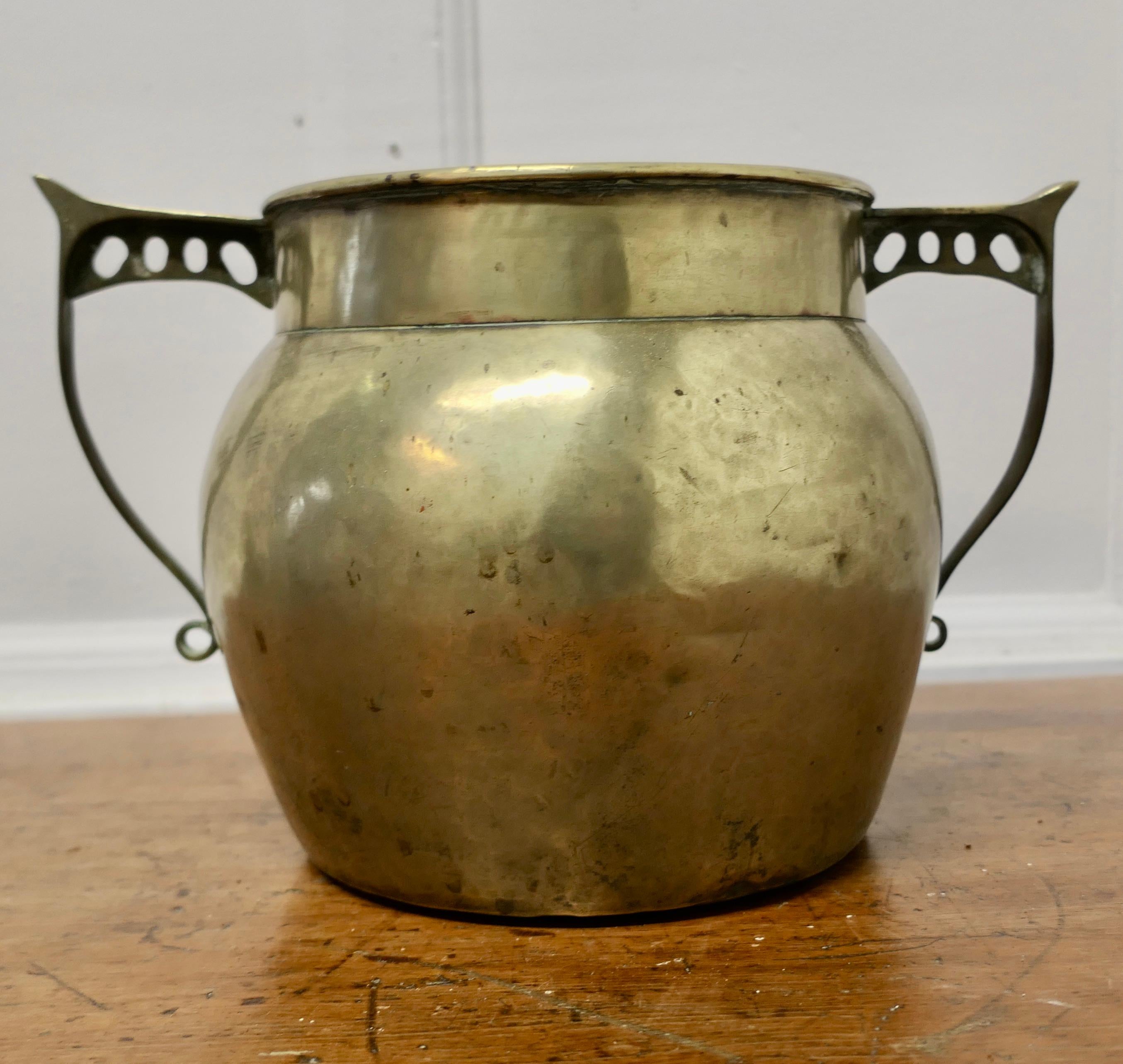Art Nouveau Brass Planter 

This is a lovely big beaten brass pot, it has a good rounded shape with stylised handles 
The cauldron is in good well aged condition, it has been used as a planter in the past it has some water stains on the inside it is