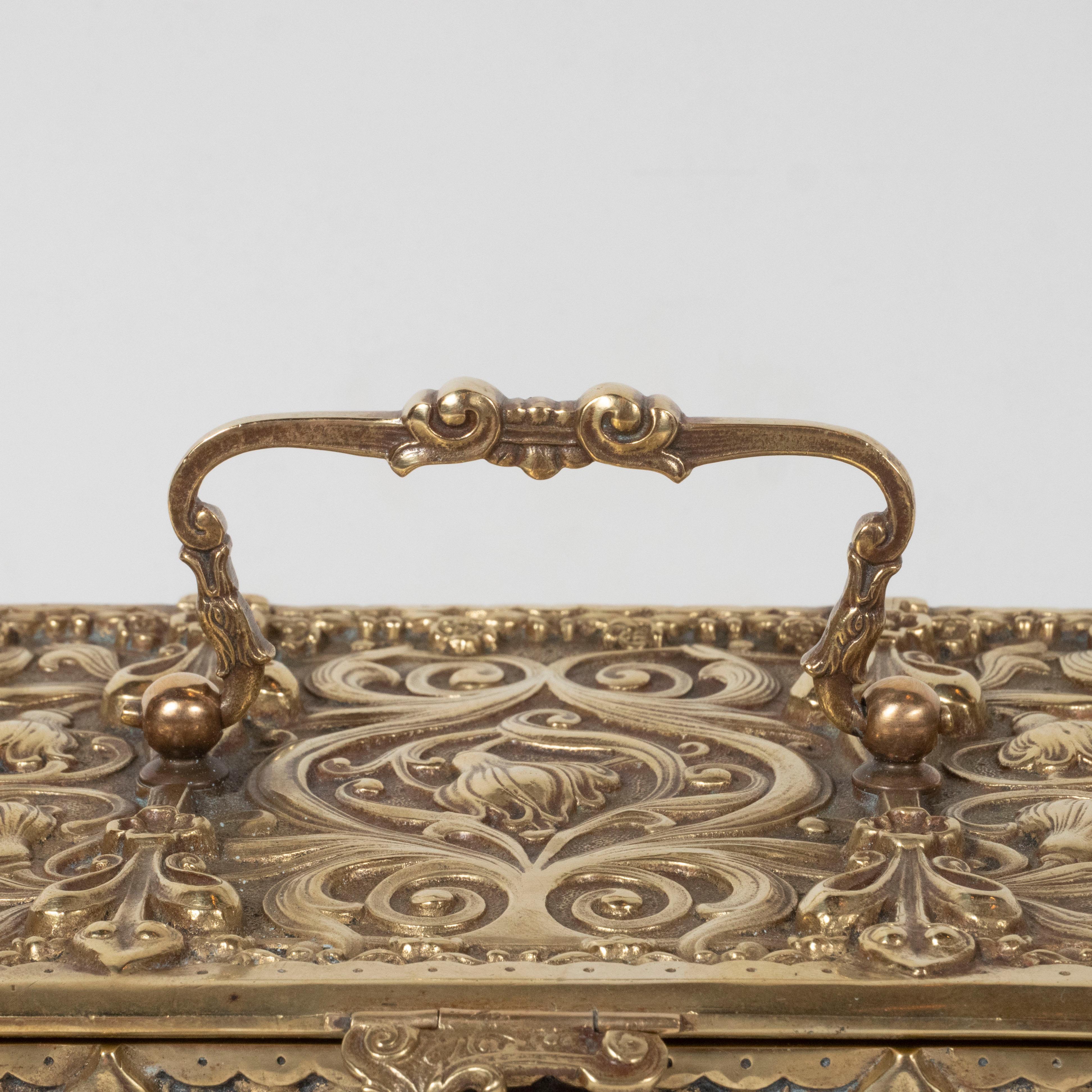 This elegant Art Nouveau box was realized in the United States, circa 1900. It features a volumetric rectangular body with stylized fleur-de-lis, foliate and foliate motifs suggesting day lilies. The piece boasts neoclassical repoussé designs etched