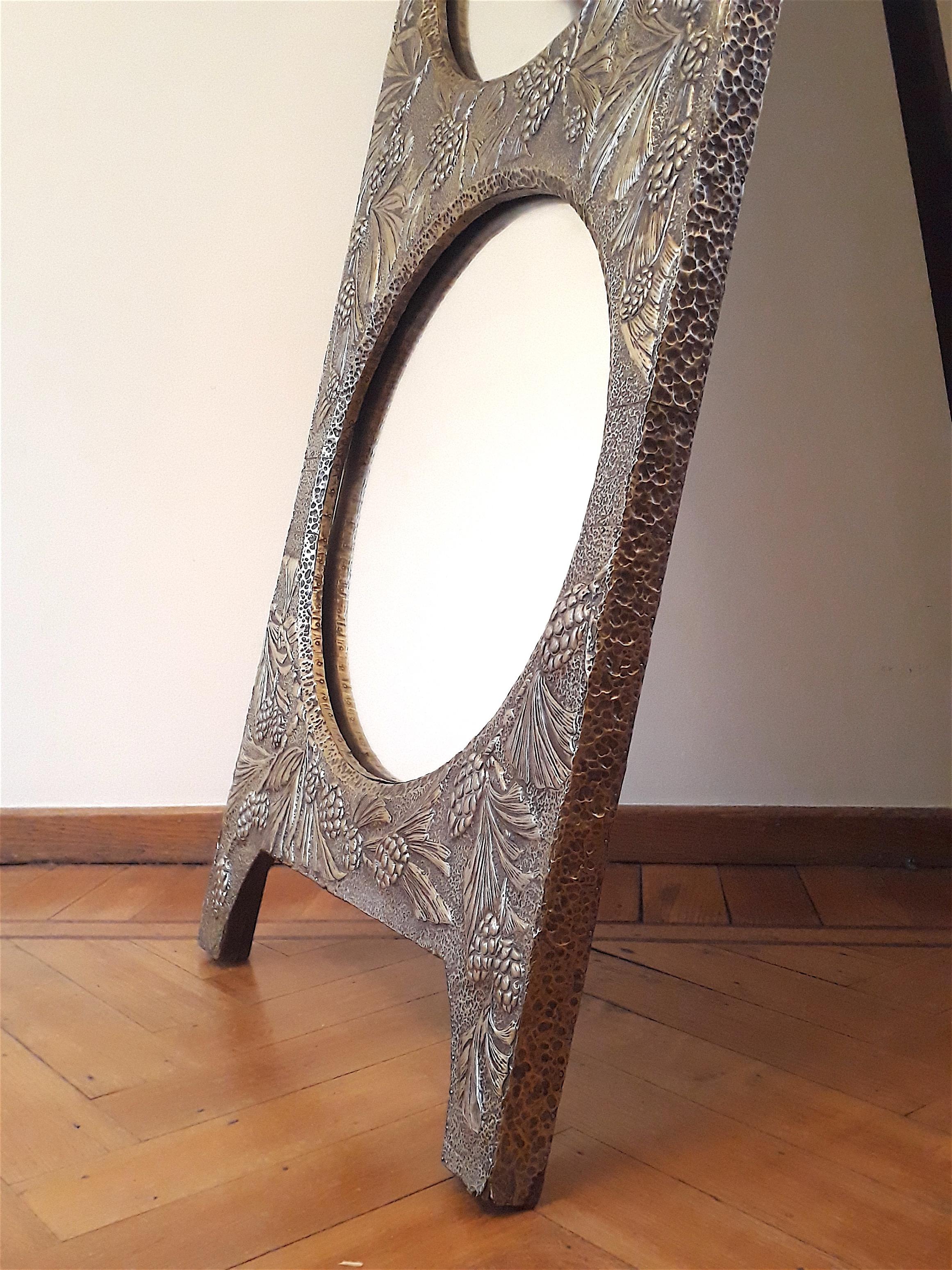 Decorative free standing Art Nouveau mirror, the front is fully covered with “pine wood” decor on brass repoussé. Beautiful craftsmanship dating from the early 20th century.