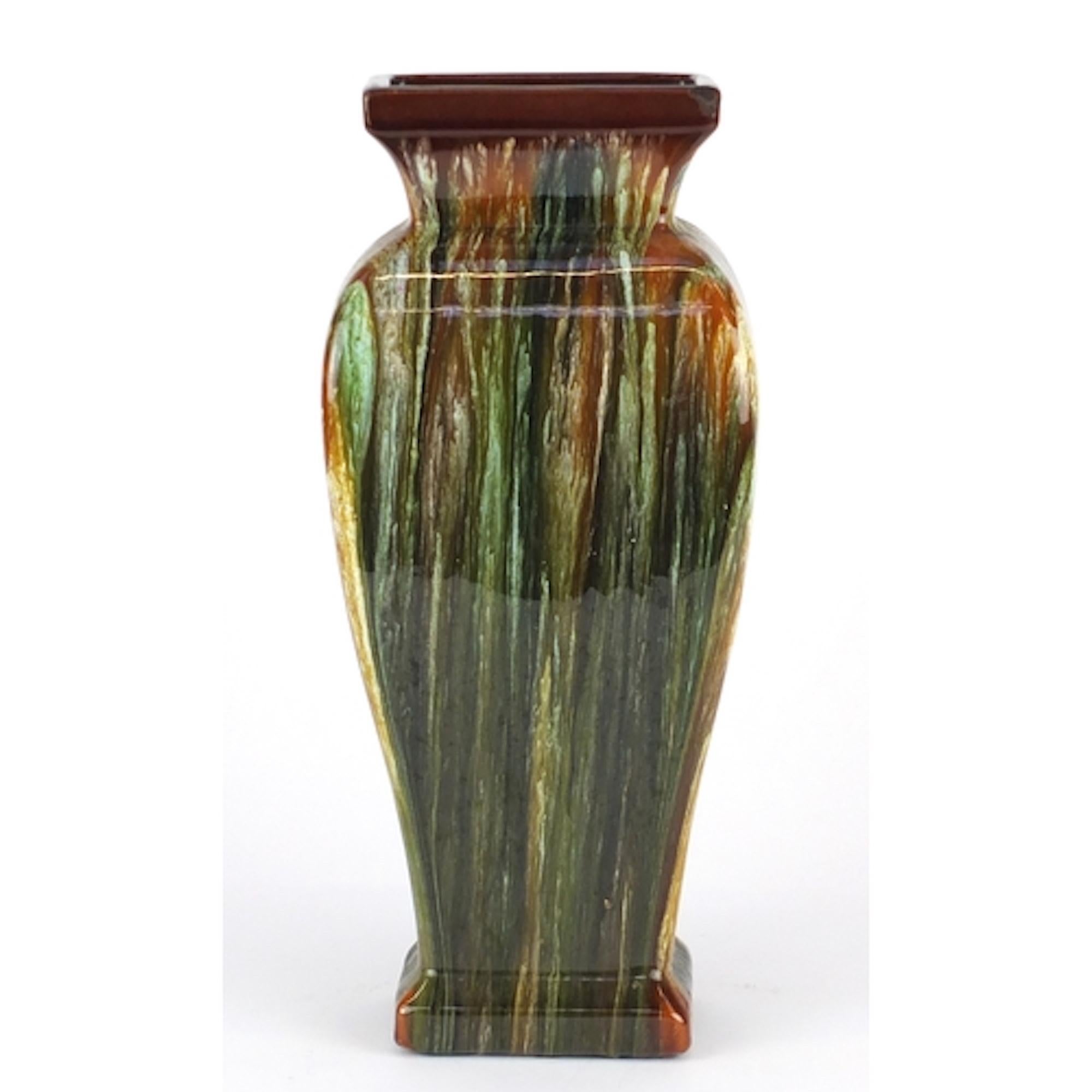 Art Nouveau Bretby vase is an original decorative object realized in the 20th century by Bretby Art Pottery. 

Original ceramic vase with a dripping glaze, in the style of Christopher dresser, impressed marks and numbered 2167H. 

This beautiful
