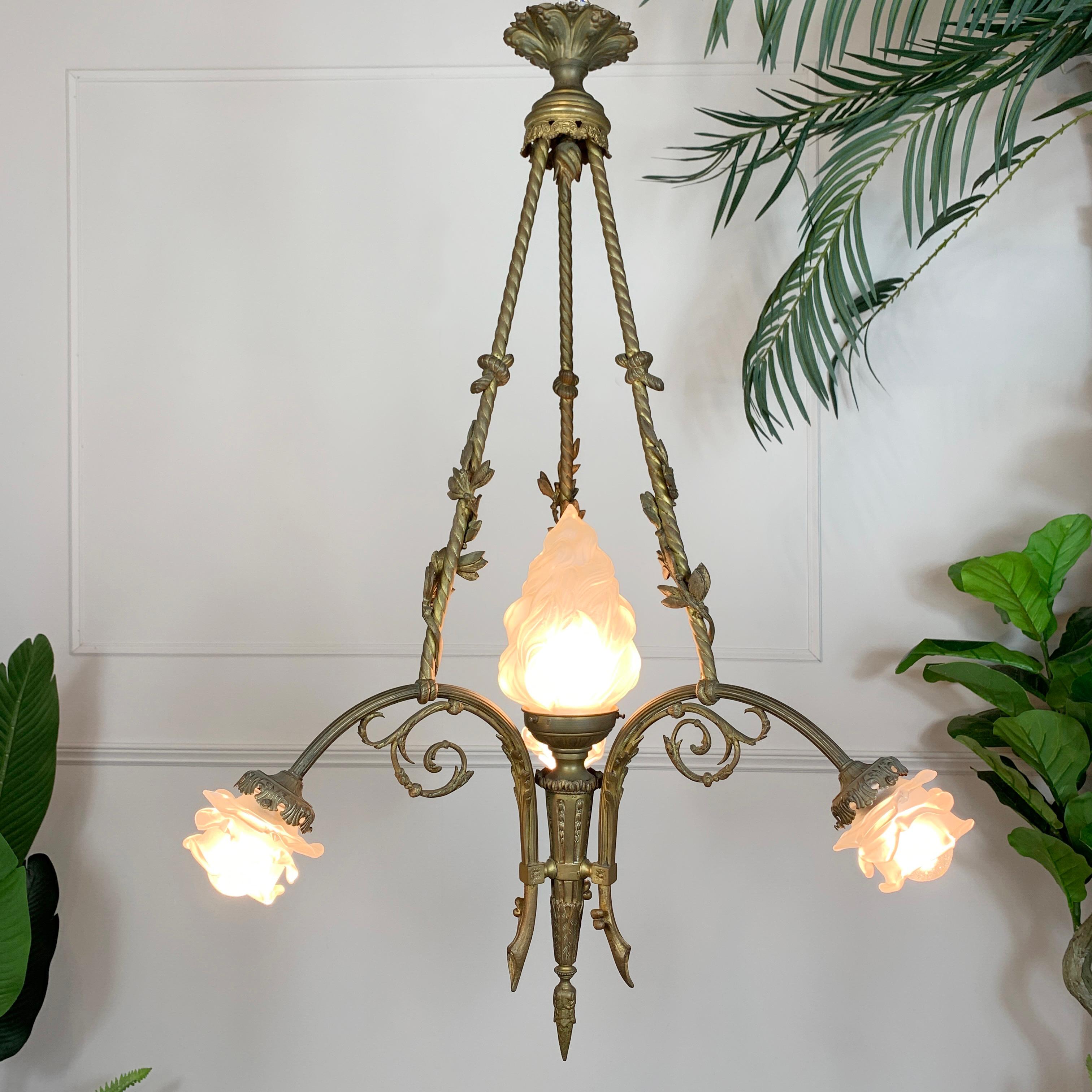 An exceptional Art Nouveau chandelier, dating to circa 1905, the bronze rope twist chandelier arms are adorned with smaller twists of rope and leaf decorative flourishes. The three branches of the chandelier each bears a cut glass shade in the form