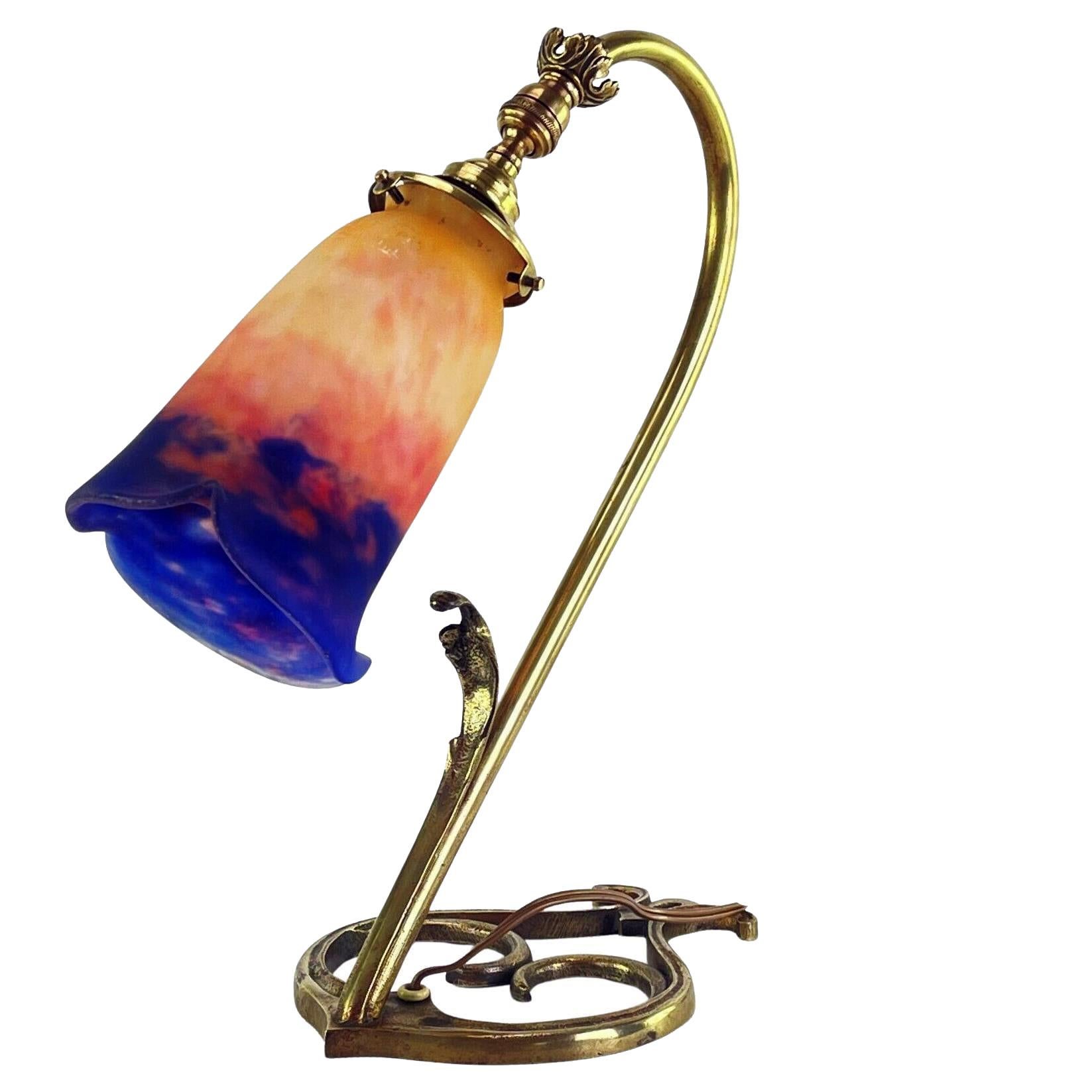 Art Nouveau bronze glass desk lamp, France C.1910 Muller Frères, Luneville. The lamp style of Louis Majorelle (French designer late 19th century renowned for organic use of curves) supporting an attractive pate-de-verre lampshade in orange, red and