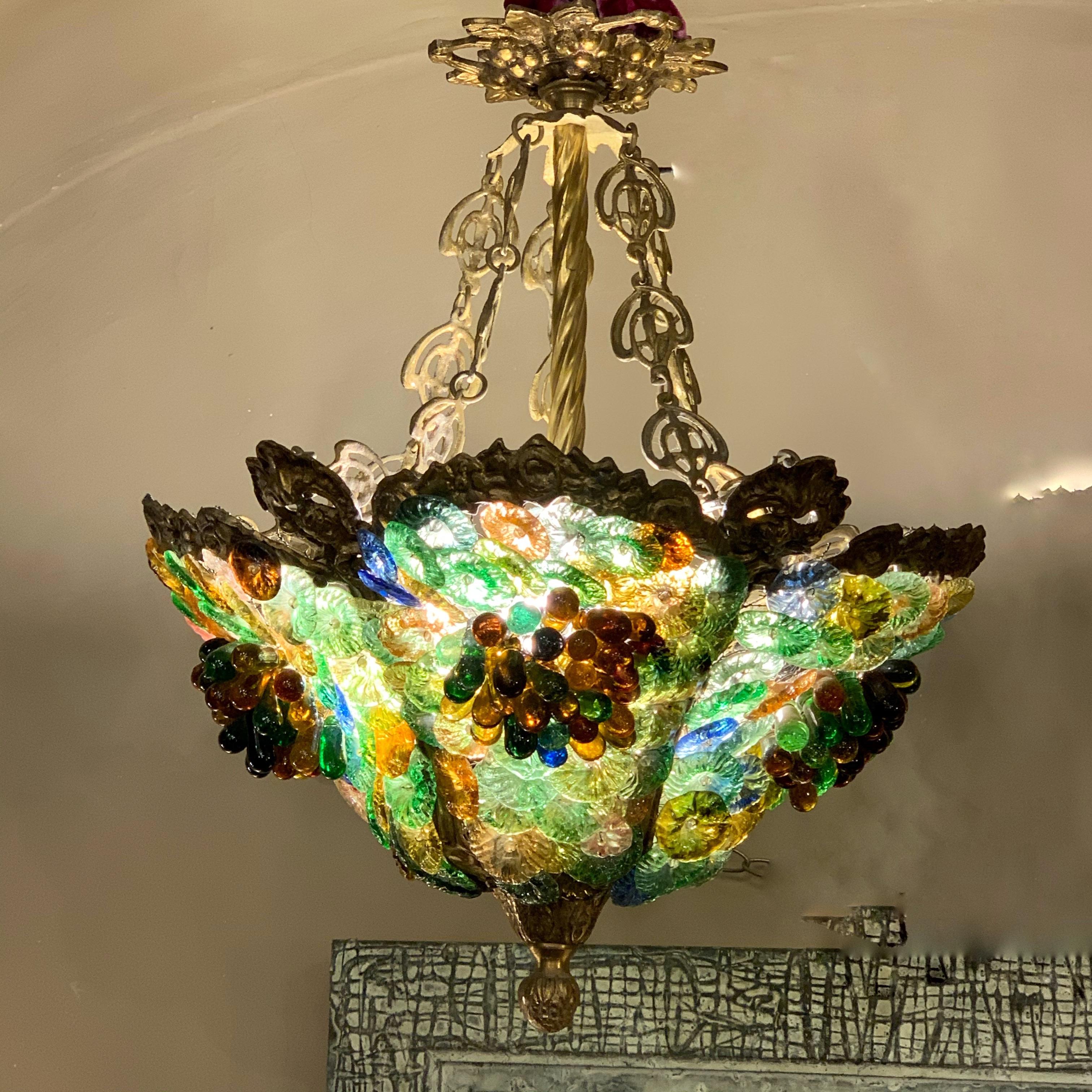 Art Nouveau bronze chandelier with multicolored pieces of Murano glass. Three bulb lamps.