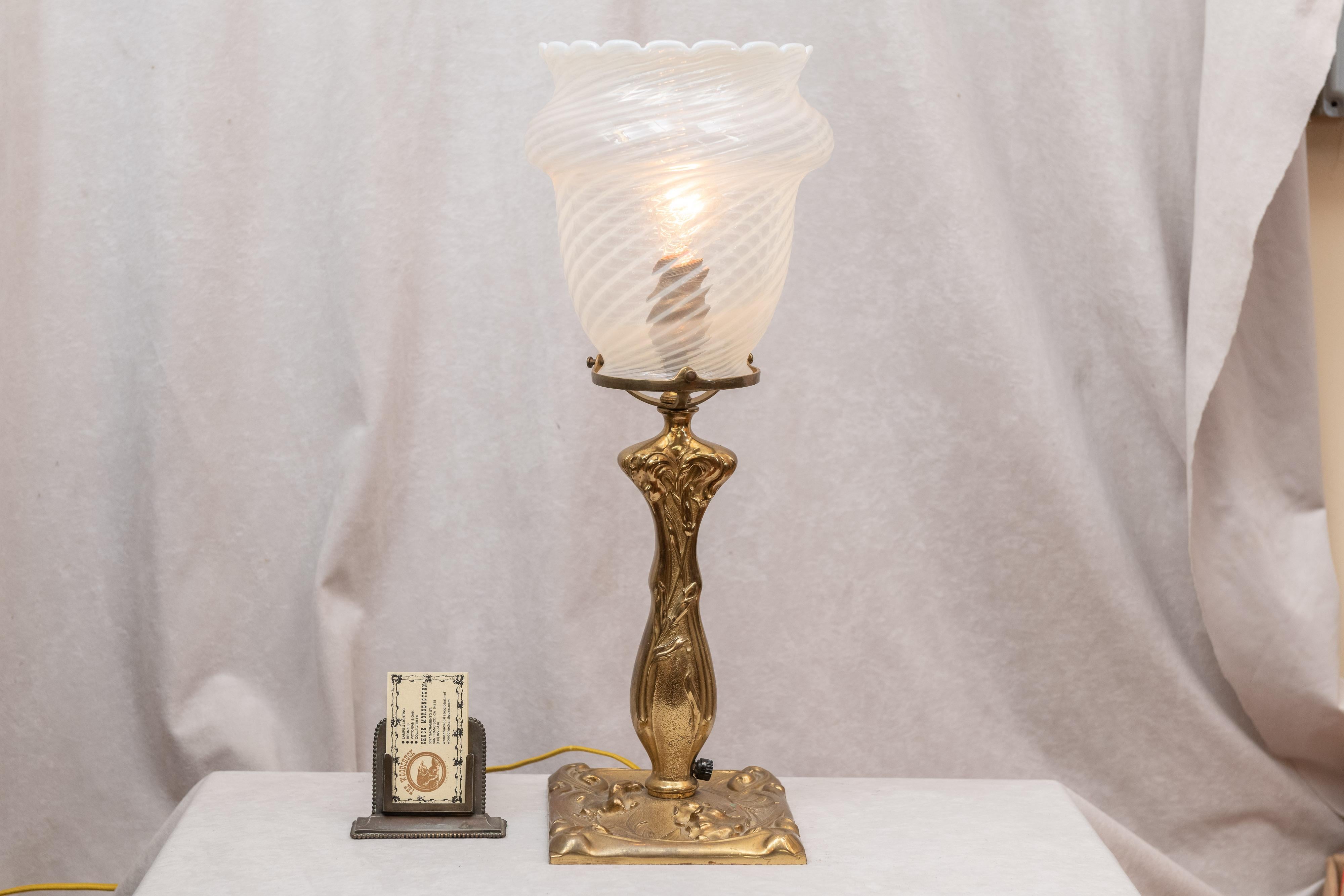 We had this wonderful Art Nouveau bronze lamp base and we waited for a glass shade that would compliment, and so years later we found a shade that we thinks works fine. The shade is very large and dynamic and is hand blown. We refer to that glass as