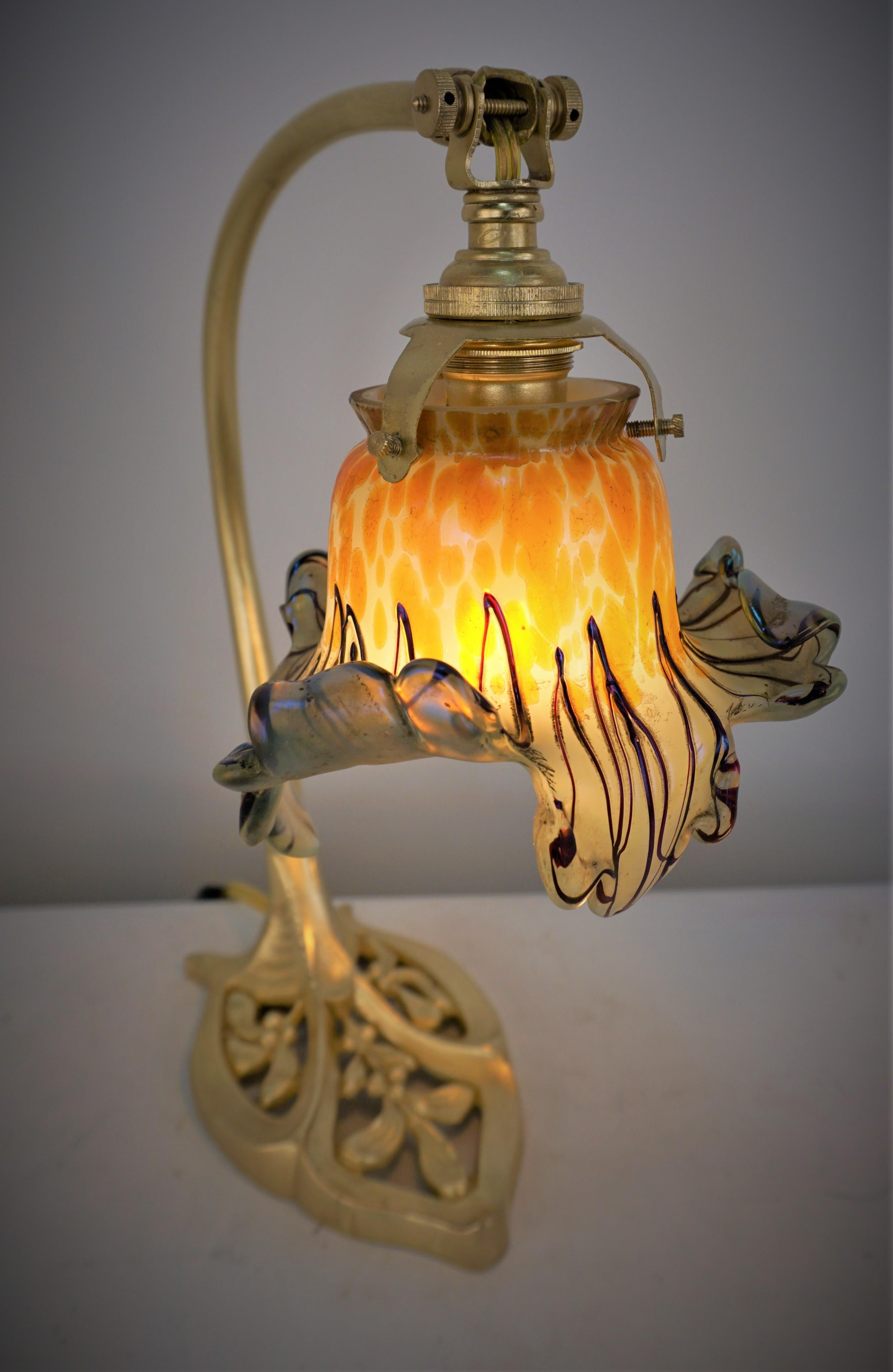 Dore bronze art nouveau table lamp with beautiful multi color hand blown glass shade.
Professionally rewired. 