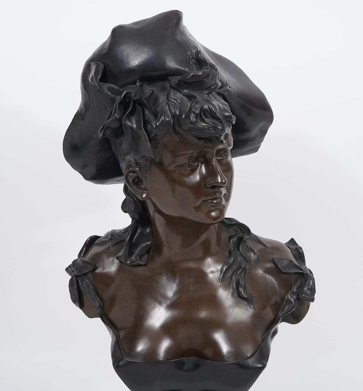 Standing 29 inches tall this bust of a young woman sporting a Louis IV era costume by French sculptor Alfonse Henri Nelson (1854-1909) is a fine example of the new Art Nouveau style modeled with flowing forms, soft lines and a combination of two