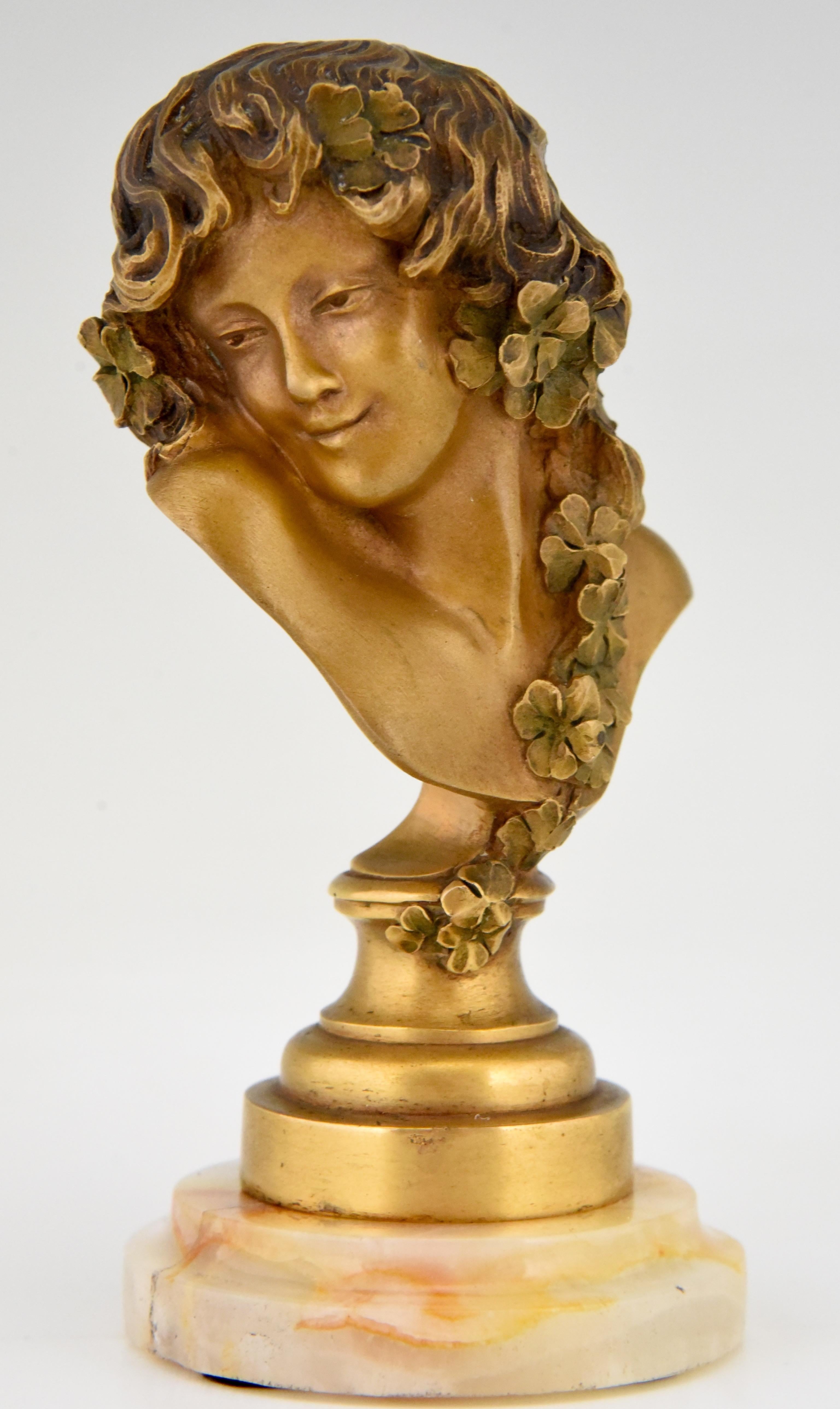 Art Nouveau bronze bust of a woman with flowers in her hair by the French artist Claire Jeanne Roberte Colinet. Signed and with foundry mark. The bronze has a lovely gilt patina and stands on a fine marble base.
Literature:
“Art Deco and other