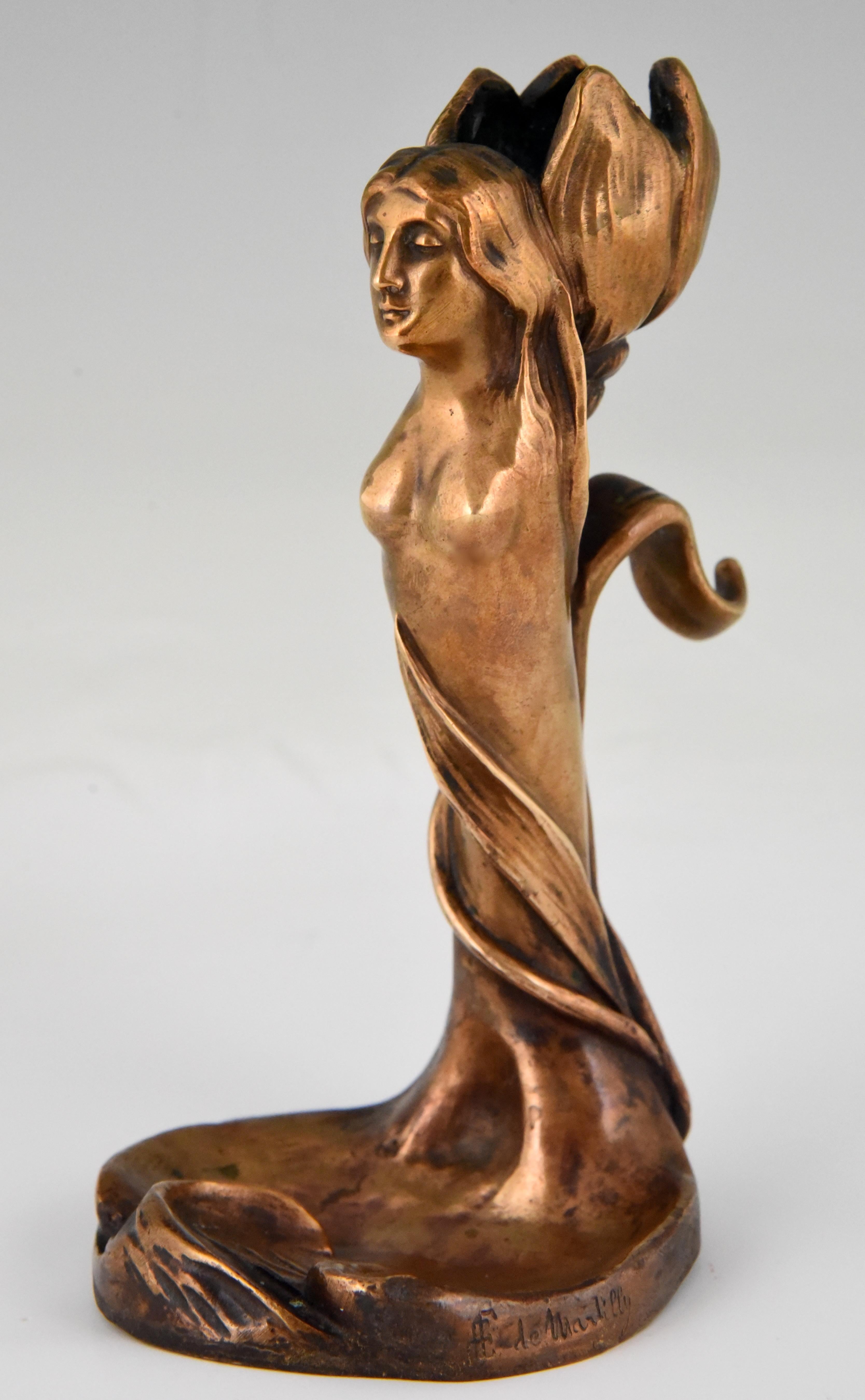 Art Nouveau bronze candlestick with nude and flower signed by the French artist Edouard de Martilly, circa 1900.