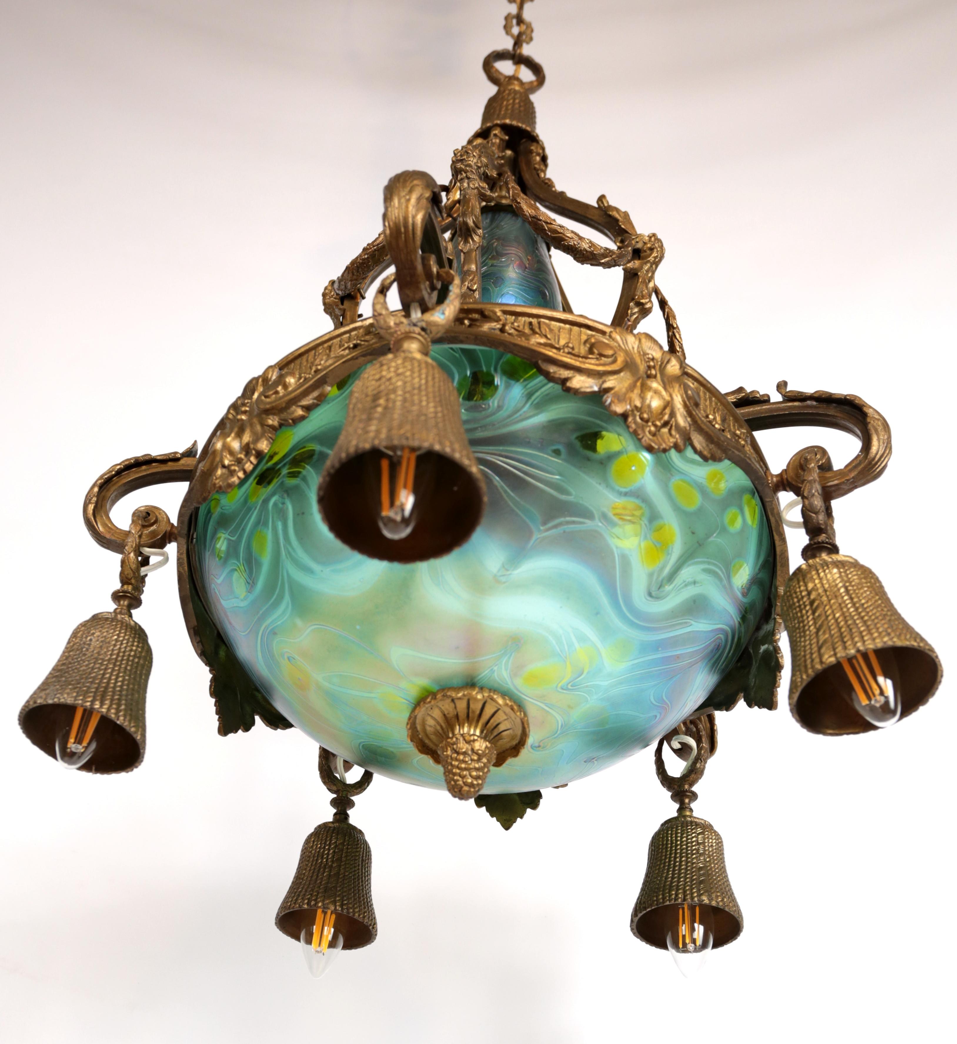 Patinated Art Nouveau bronze chandelier with iridescent glass shades For Sale