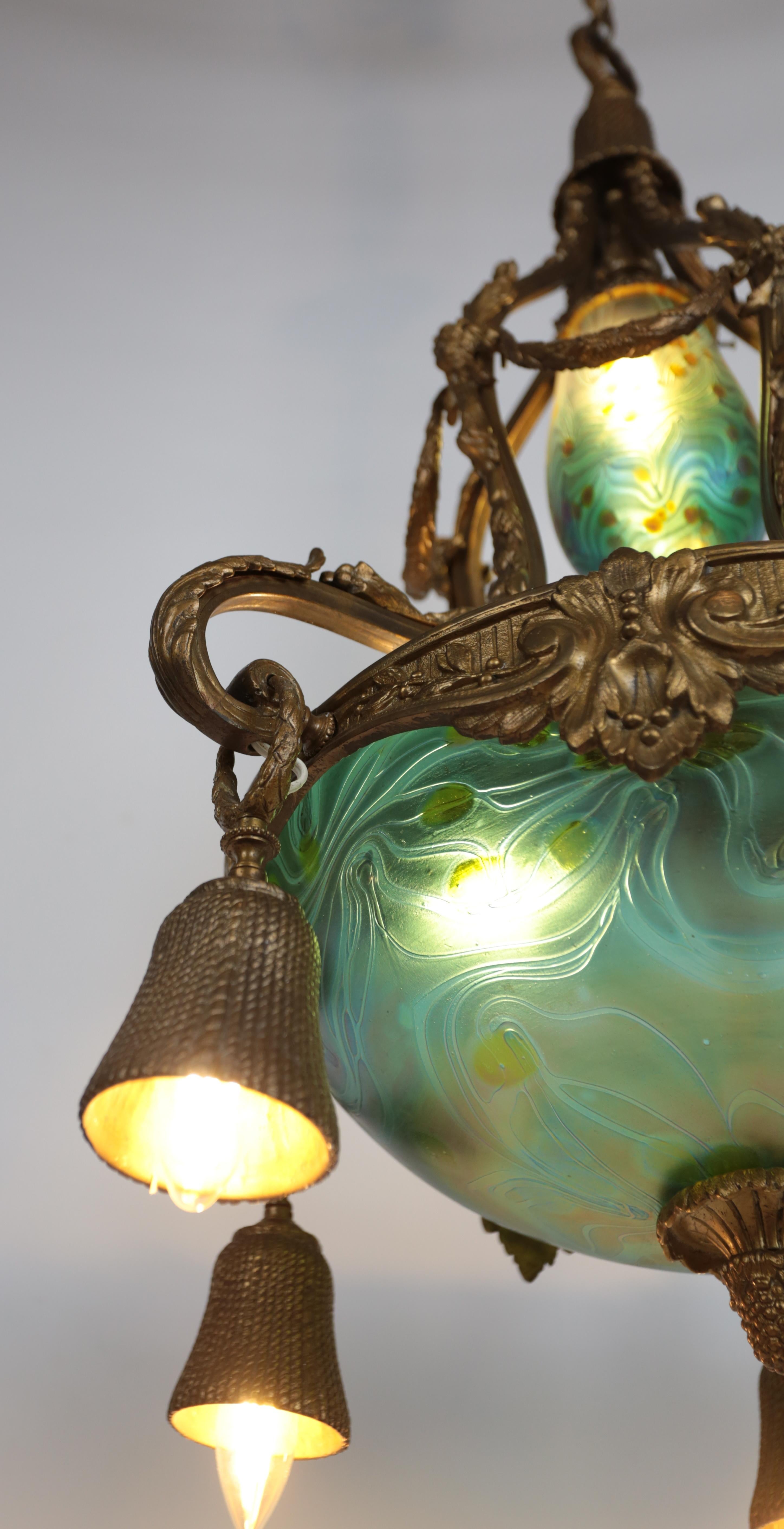 Bronze Art Nouveau bronze chandelier with iridescent glass shades For Sale