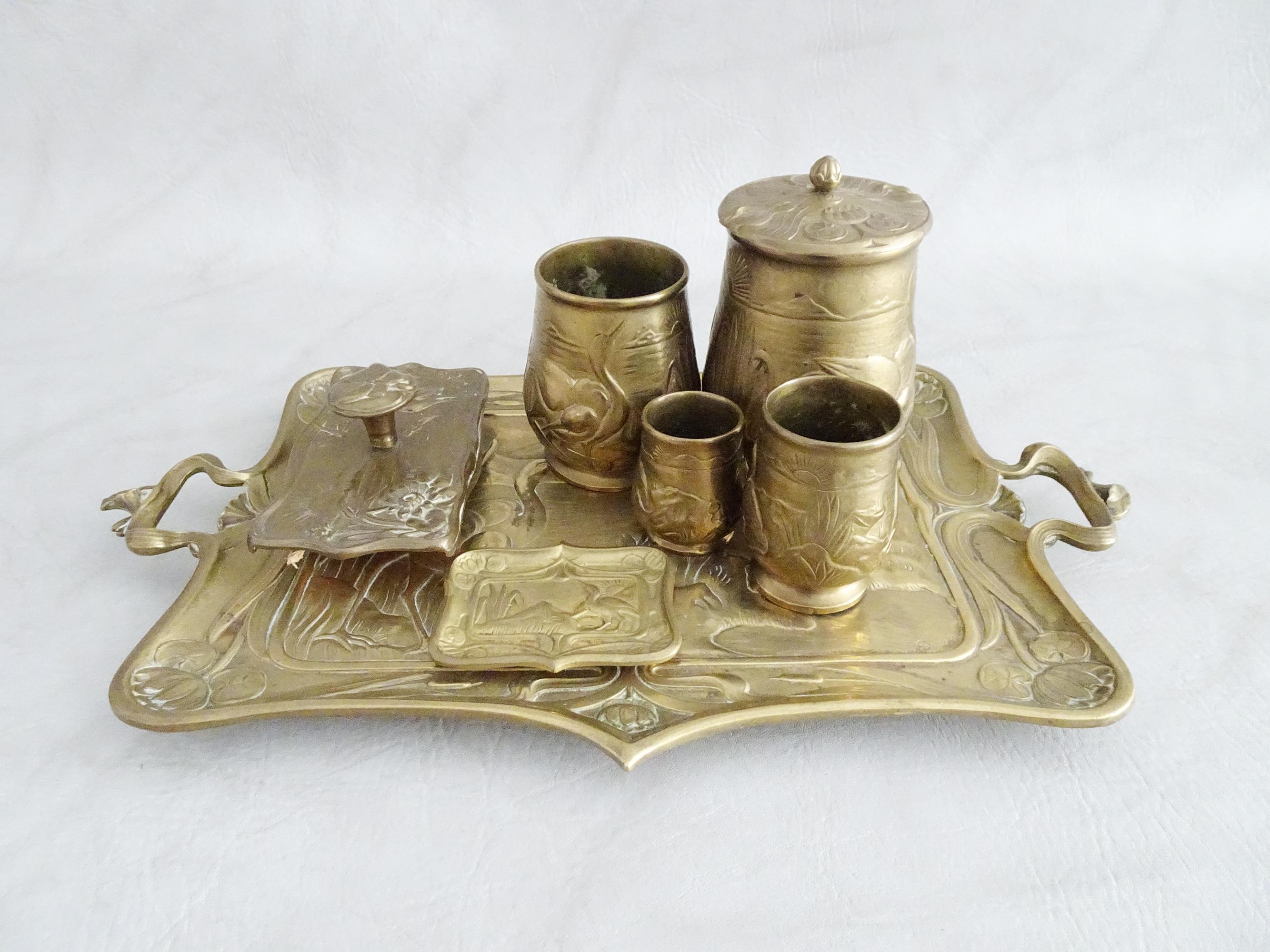 Stylish French Original Art Nouveau desk set made of bronze. The high-quality set consists of seven parts and is made of heavy bronze. Beautifully worked in detail with a scenery of herons on the water.

The brass set consists of a large tray, a
