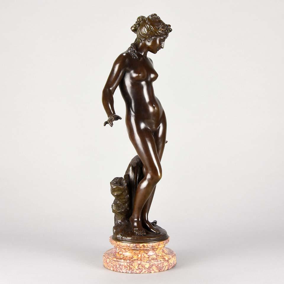 A very pretty late 19th century Art Nouveau bronze study of a young beauty standing beside a brook, a dragonfly by her foot, with excellent rich red/brown patina and very fine detail, raised on a marble base and signed Aug Moreau.