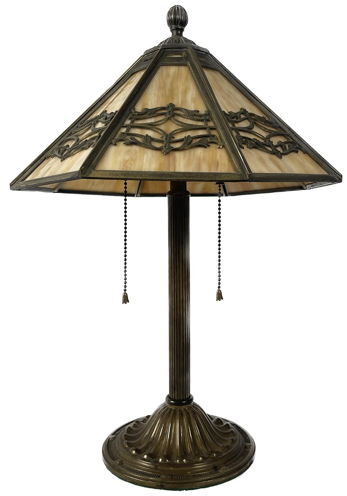 An early 20th century Art Nouveau style bronze table lamp with slag glass. 

Dimensions: 20