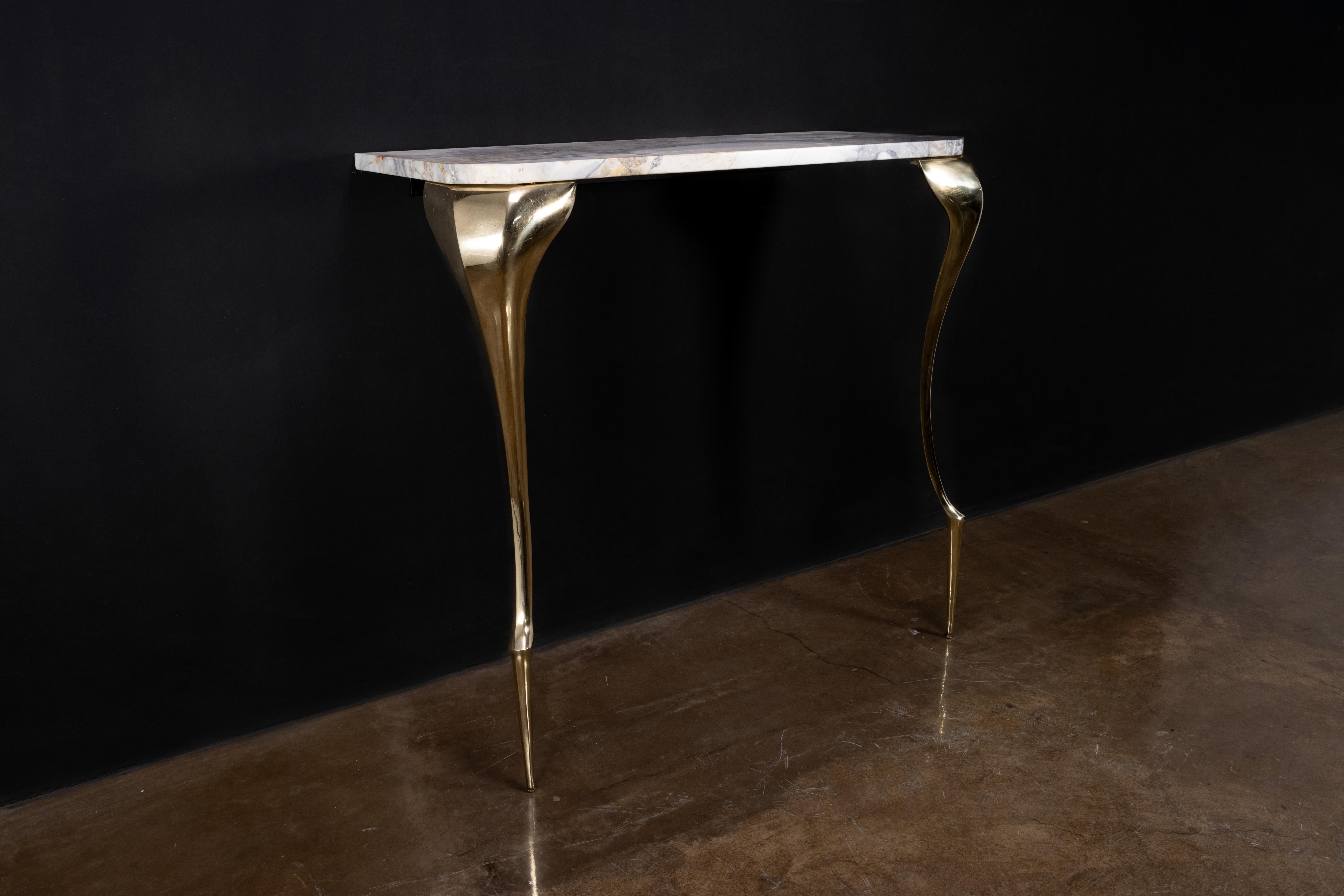 In Stock as shown 

The Lychorinda Console table balances modern scale and proportion with Art Nouveau influences. Shown in cast polished bronze with a Blue Jeans top, this piece can also be made in steel or aluminum and with any material top.
Other