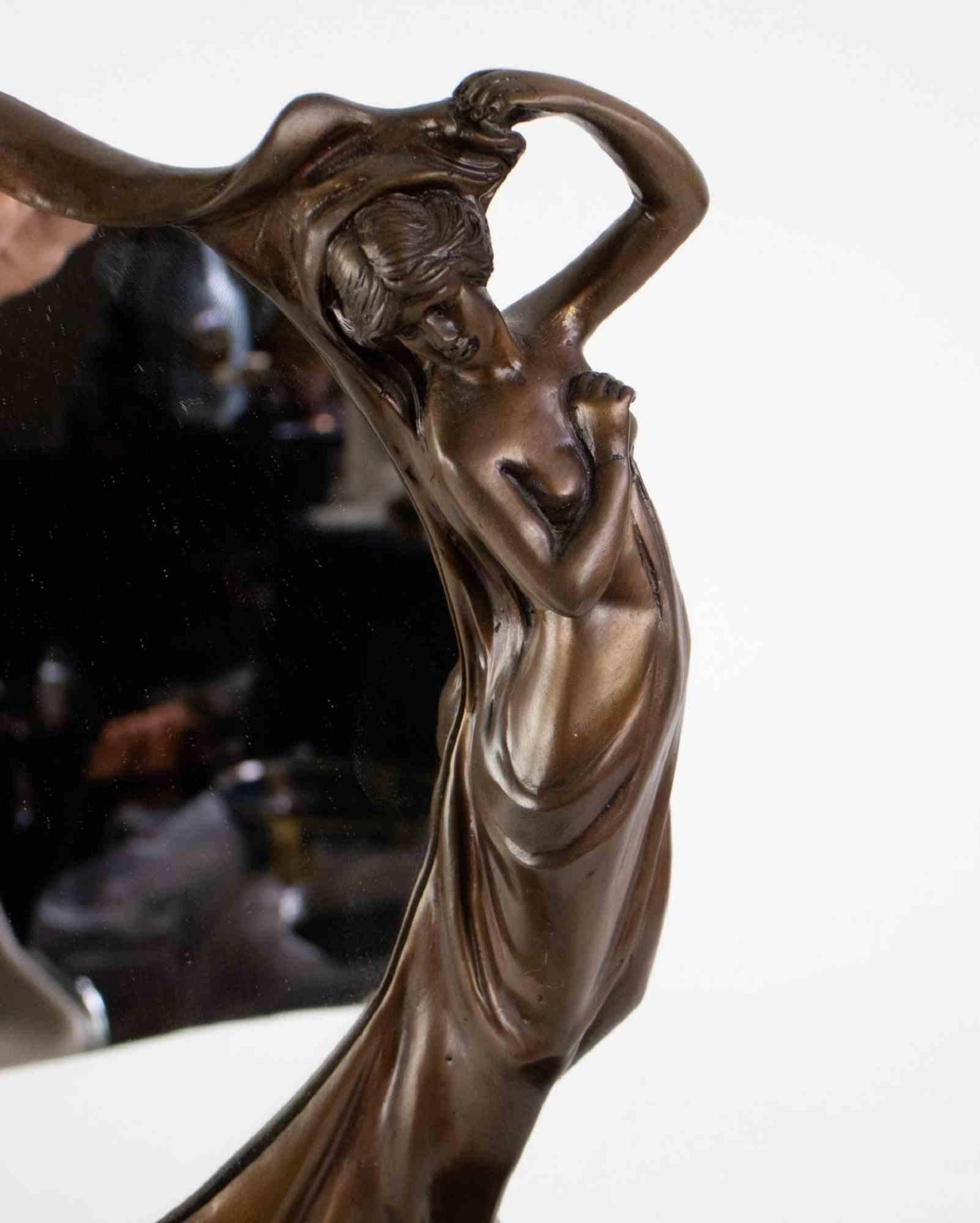 Art Nouveau bronze mirror is an original decorative object realized in the Early 20th Century

An elegant bronze mirror with a bronze female figure on one side. Realized during Art Nouveau period.