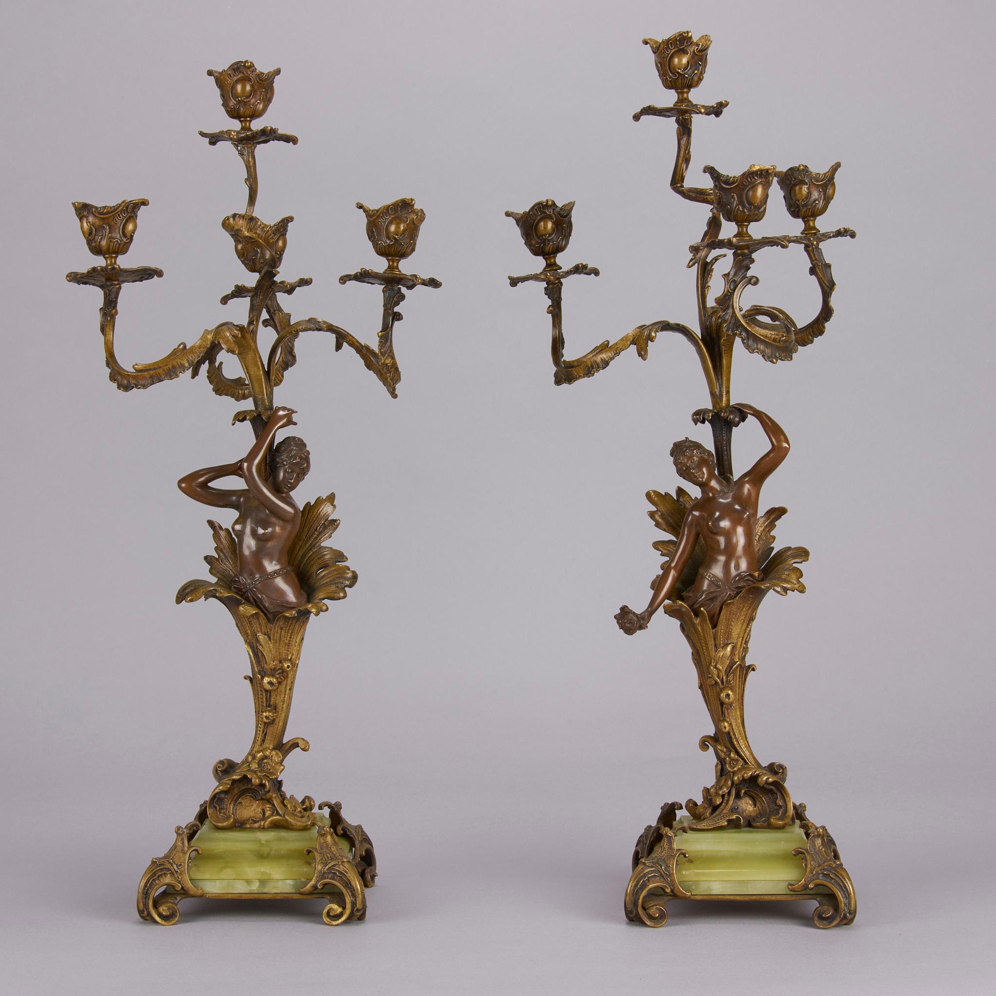 Excellent early 20th Century Art Nouveau French gilt and patinated bronze figural candelabra with the torsos of two beautidul young women each holding up four light canedelabrum and raised on decorative green onyx and gilt bronze bases. Unsigned.