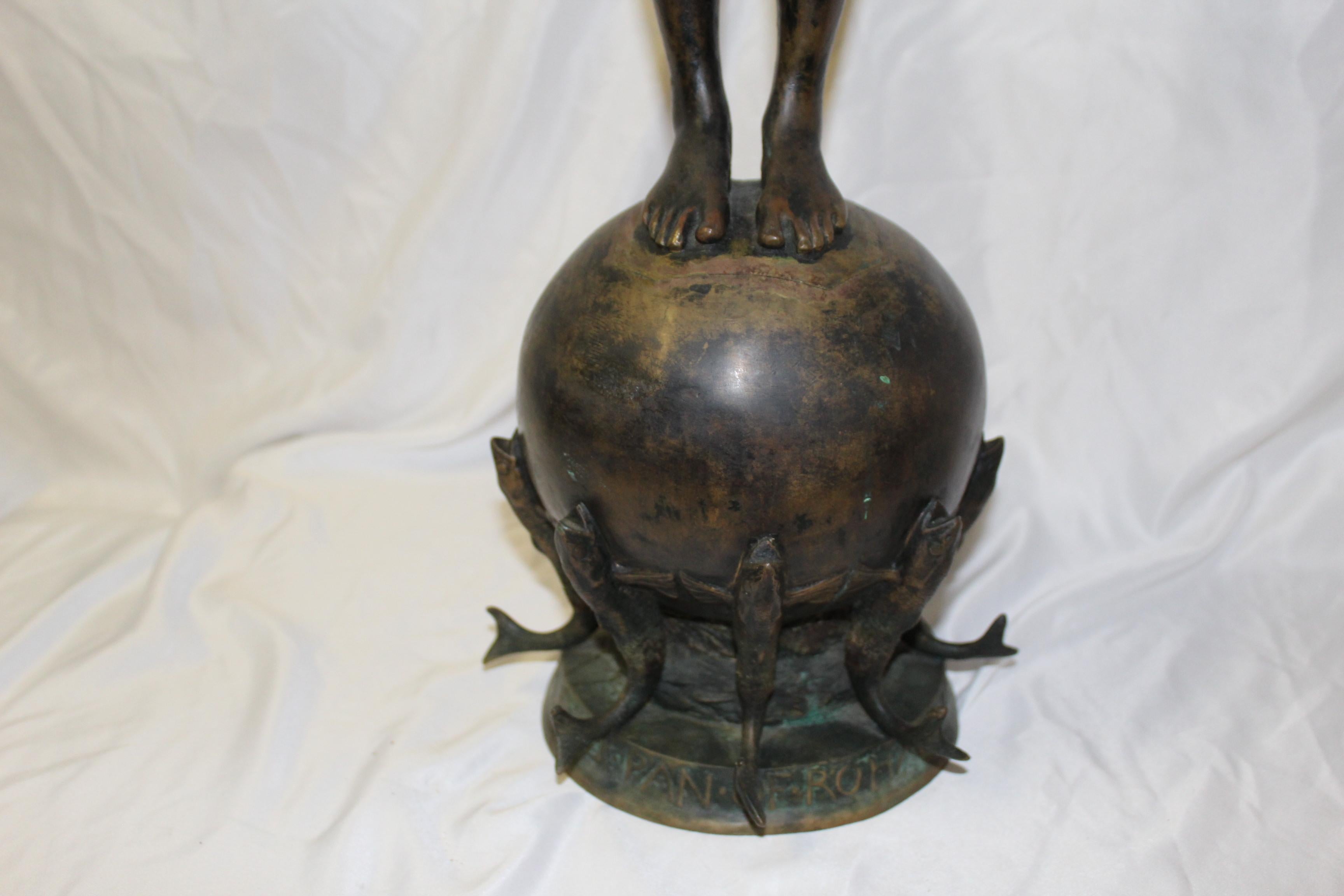 A pan boy standing on a ball supported by Fish around the base. Has the two flutes. Signed on the base Frederick William Mac Monies and dated 1890 and with the Foundry seal. Has the letters on the base (M.D.C.C.C.L.X.L.) One sold at Rago’s Auction