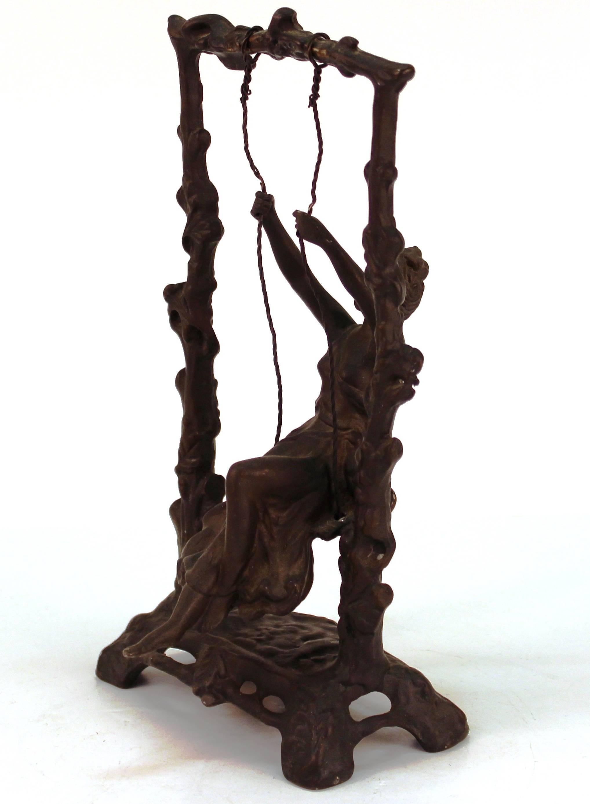 An Art Nouveau bronze sculpture of a girl on a swing, after Auguste Moreau. The piece is marked 'TD' on the bottom and is in good vintage condition.